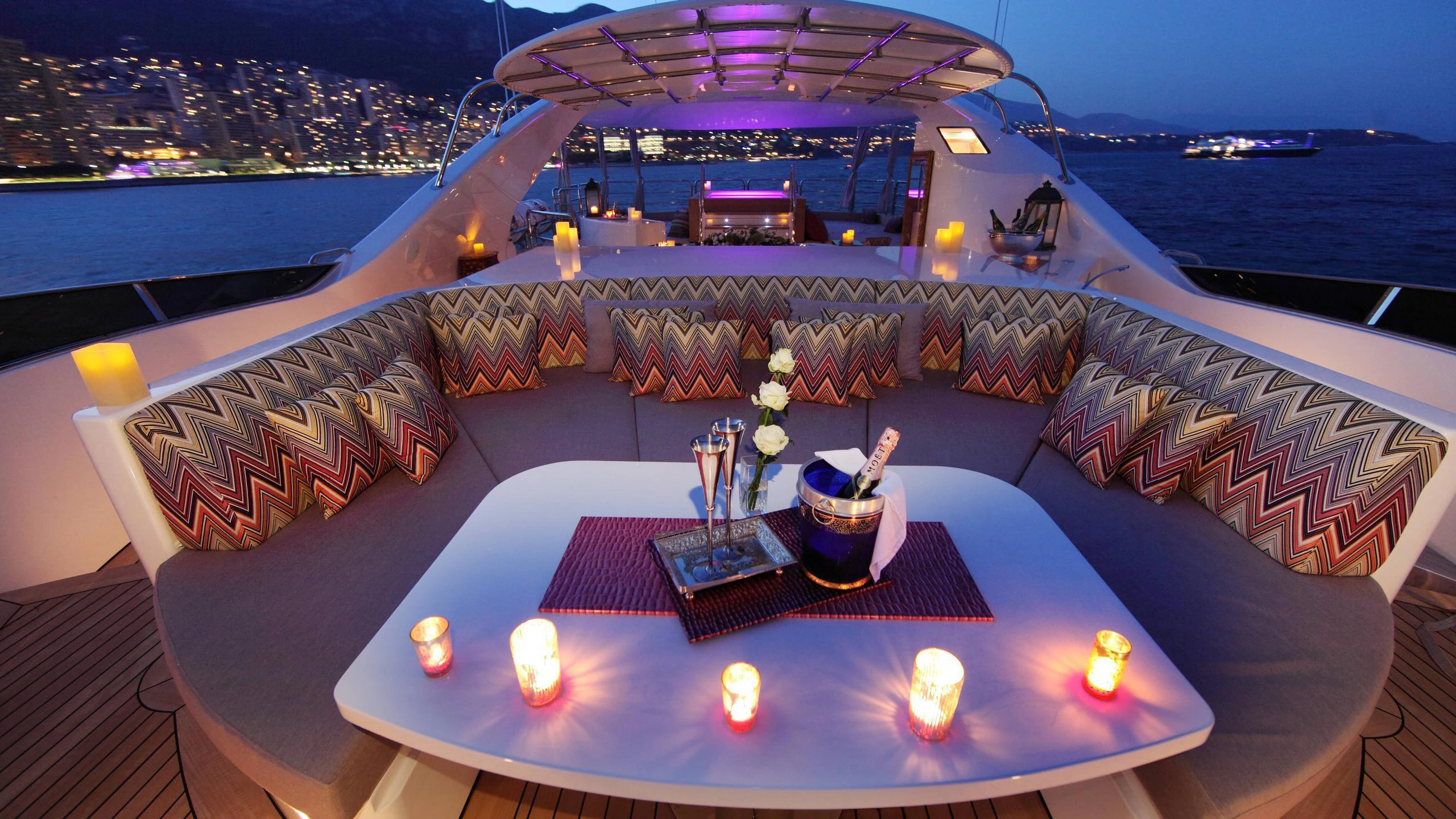 a table with candles on it aboard SUR LA MER Yacht for Charter