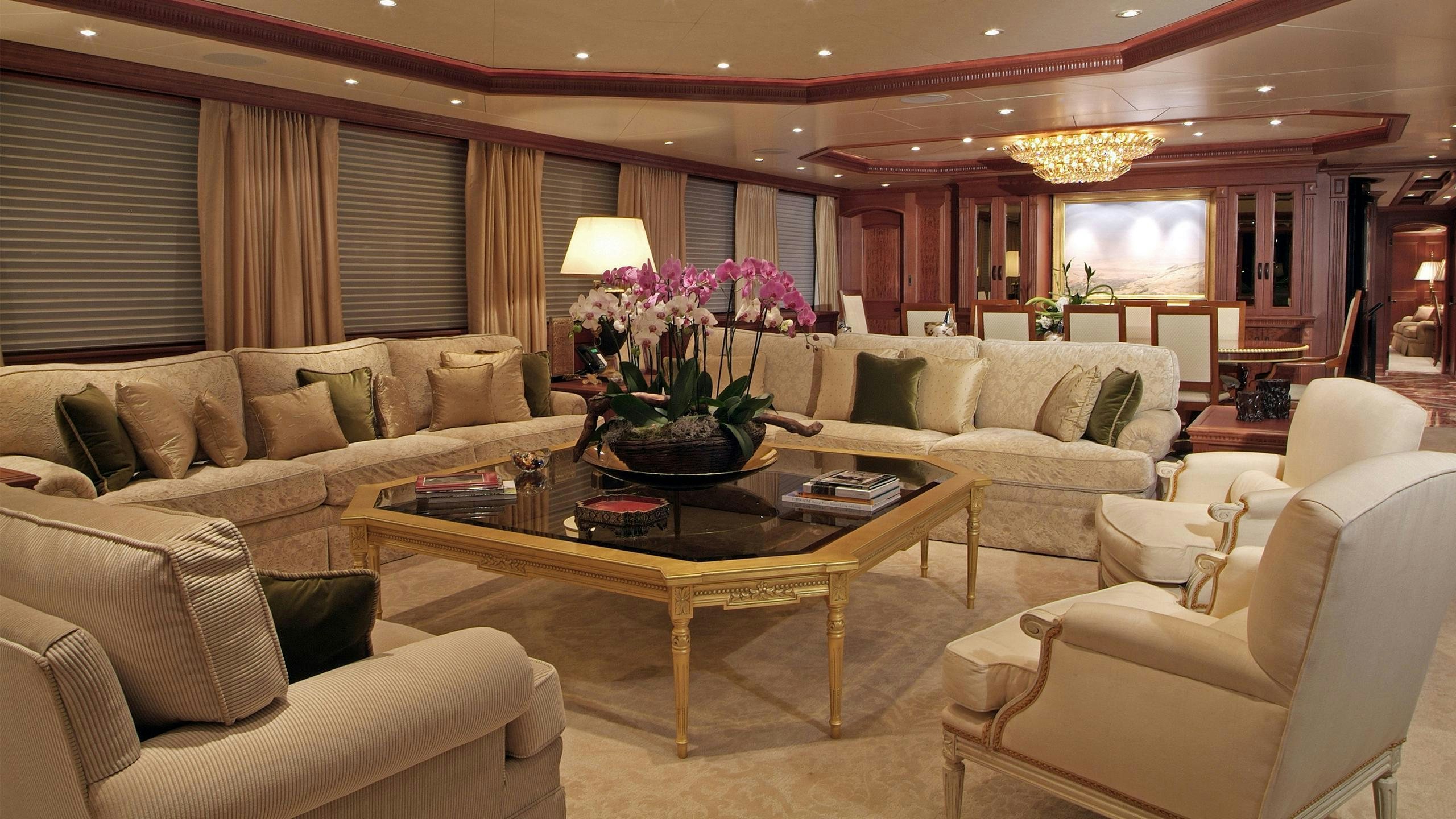 a living room with a table and couches aboard CROSSED SABRE Yacht for Charter