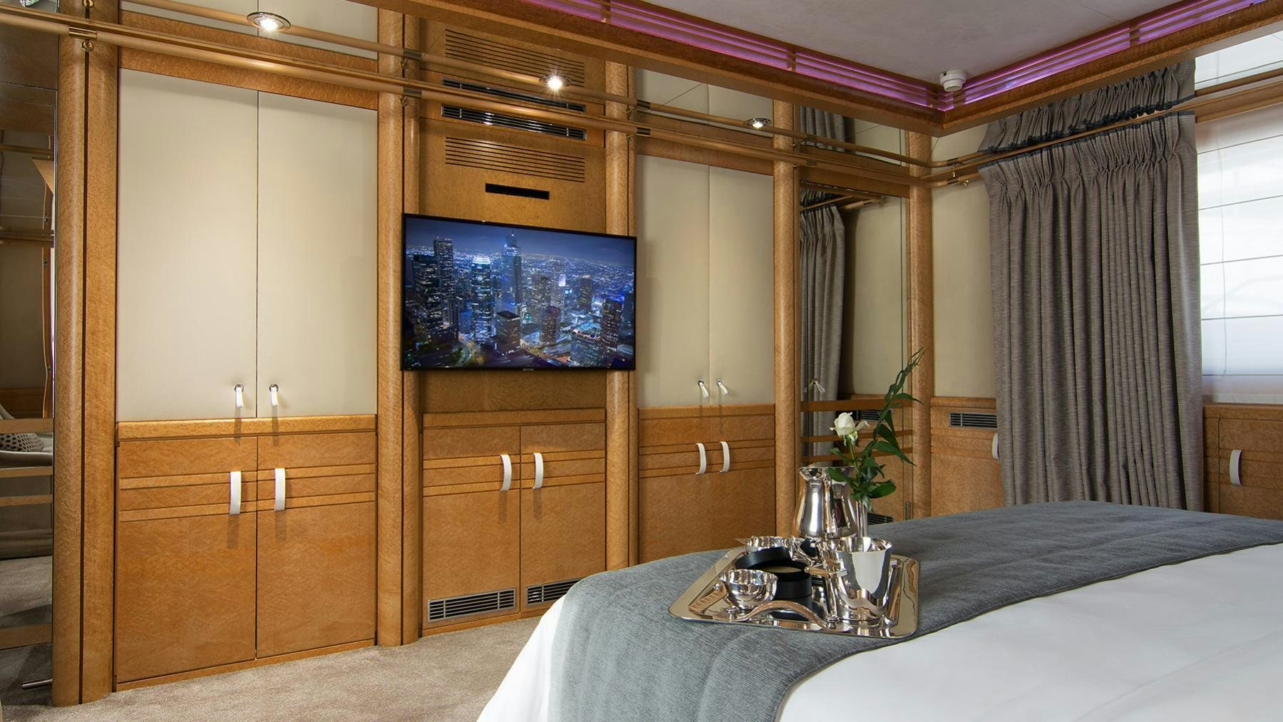 a room with a bed and cabinets aboard BELLA STELLA Yacht for Charter
