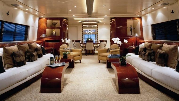 a living room with a white couch and a coffee table aboard COSTA MAGNA Yacht for Charter
