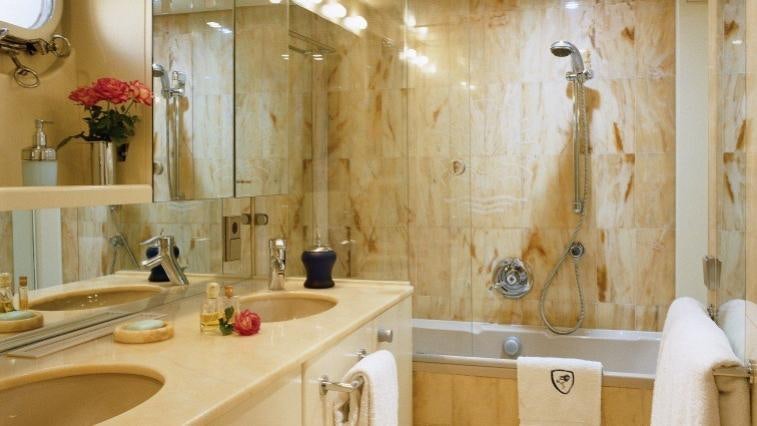 a bathroom with a shower curtain aboard COSTA MAGNA Yacht for Charter