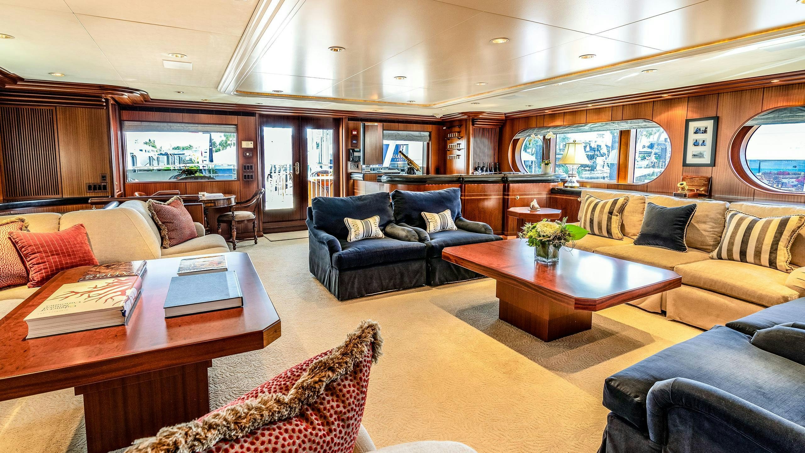 a living room with a leather couch and a table aboard NEVER ENOUGH Yacht for Charter