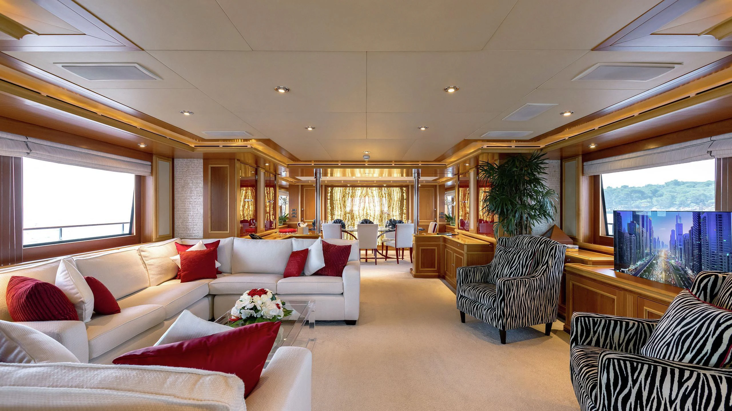 a living room with white couches and a large window aboard EMOTION 2 Yacht for Charter