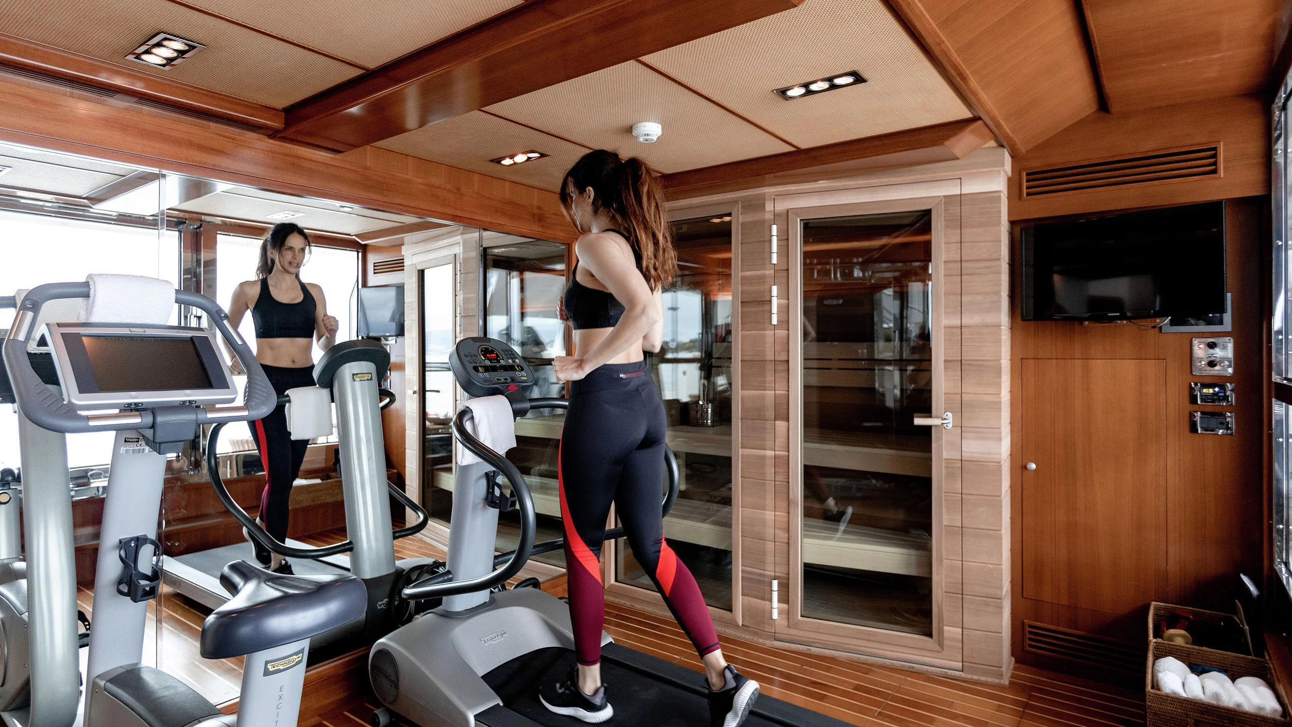 a person running in a gym aboard EMOTION 2 Yacht for Charter