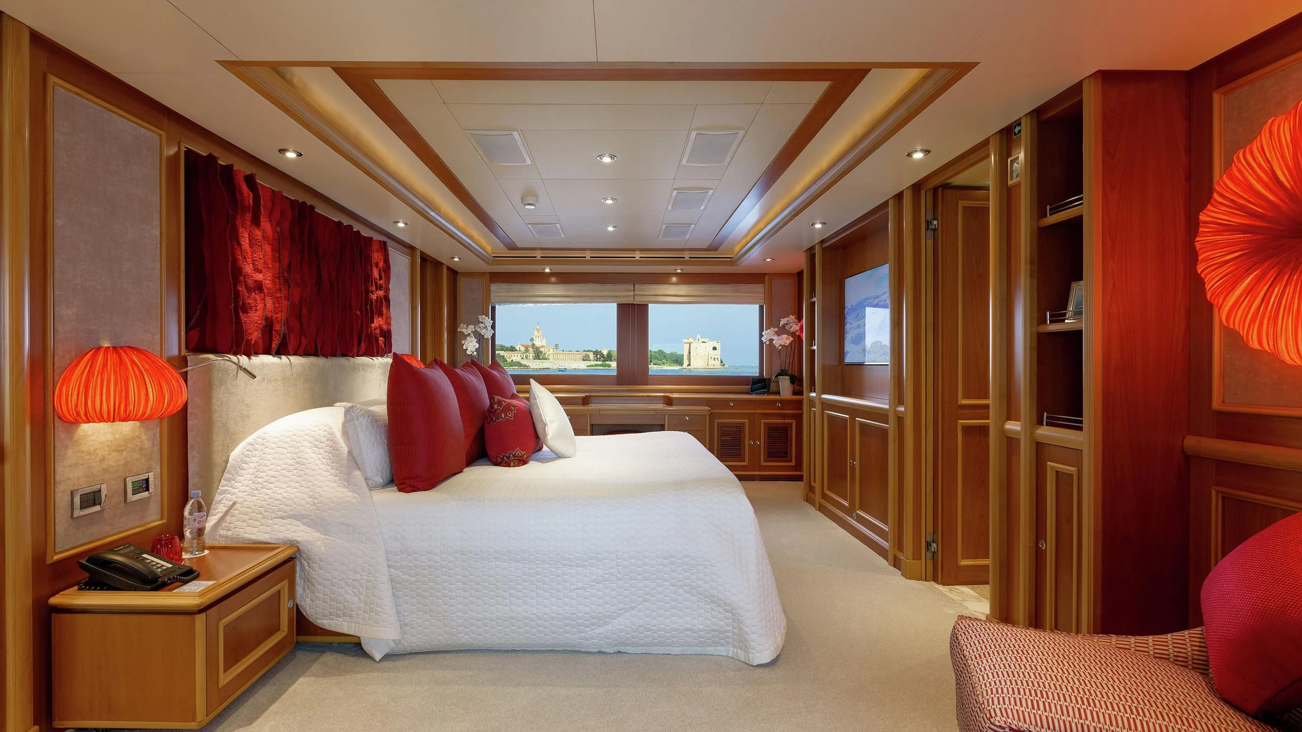 a bedroom with a bed and a desk aboard EMOTION 2 Yacht for Charter