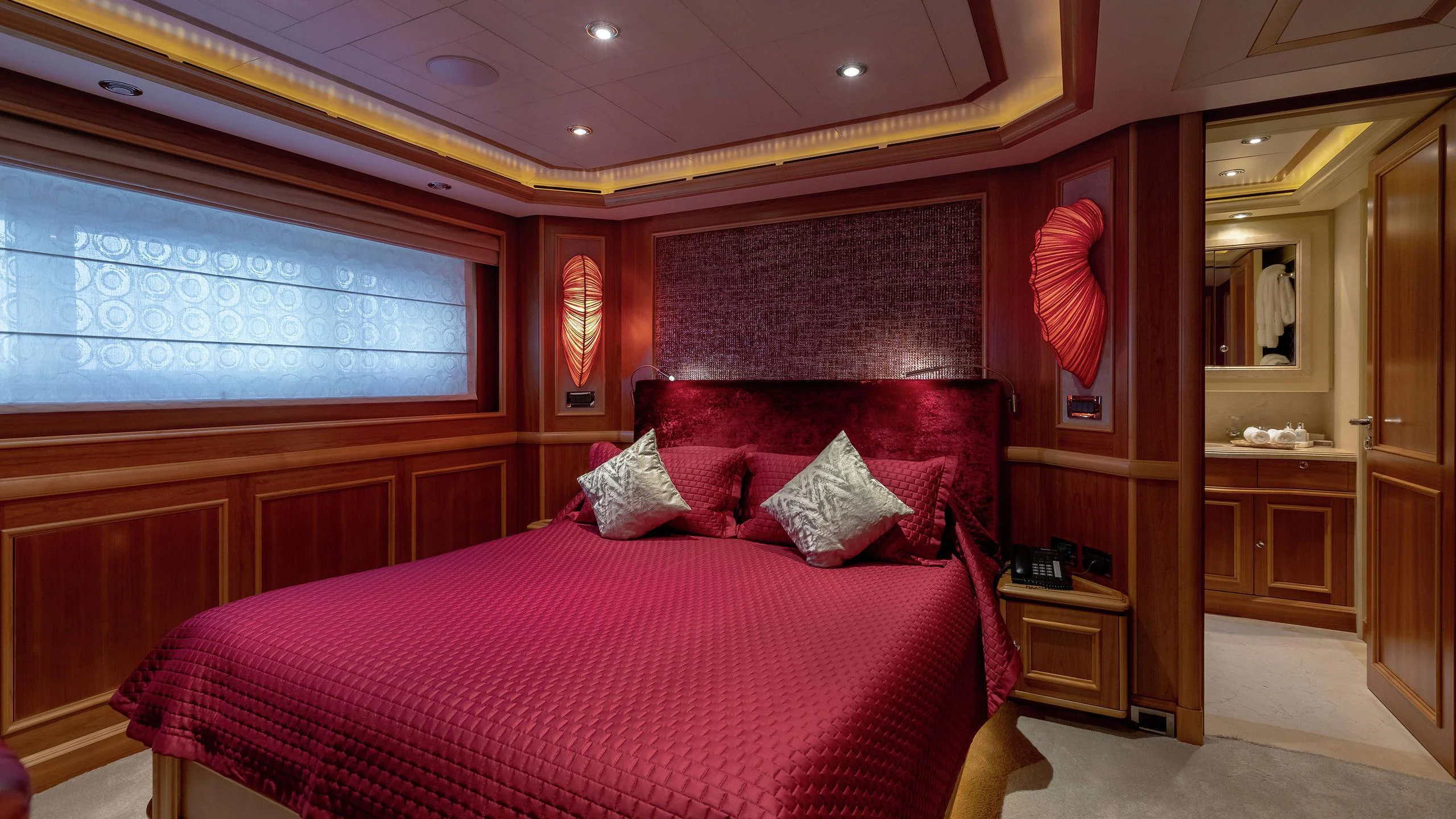 a room with a bed and a desk aboard EMOTION 2 Yacht for Charter