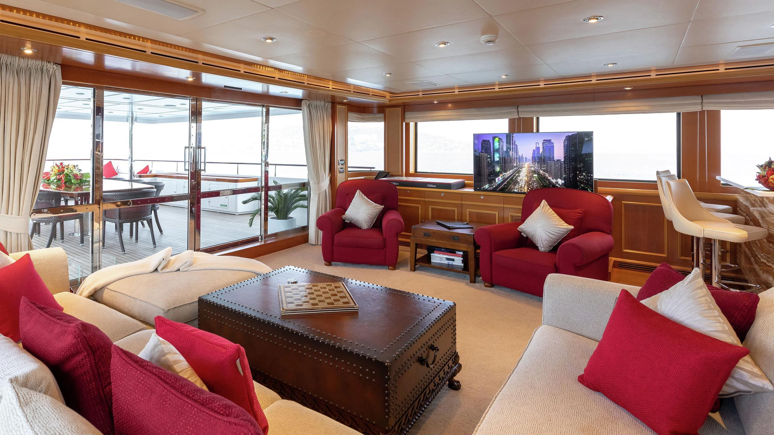 a living room with red couches and a television aboard EMOTION 2 Yacht for Charter