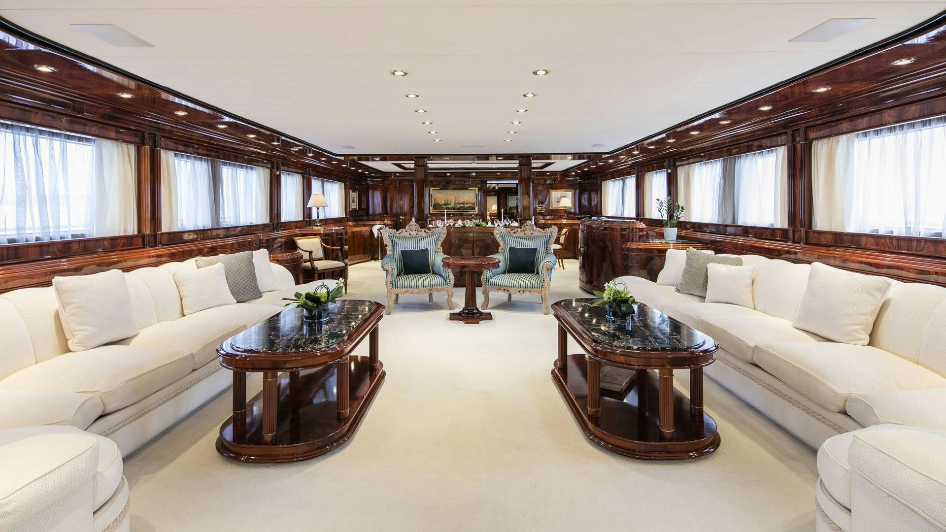 a living room with a couch and a coffee table aboard JAAN Yacht for Charter