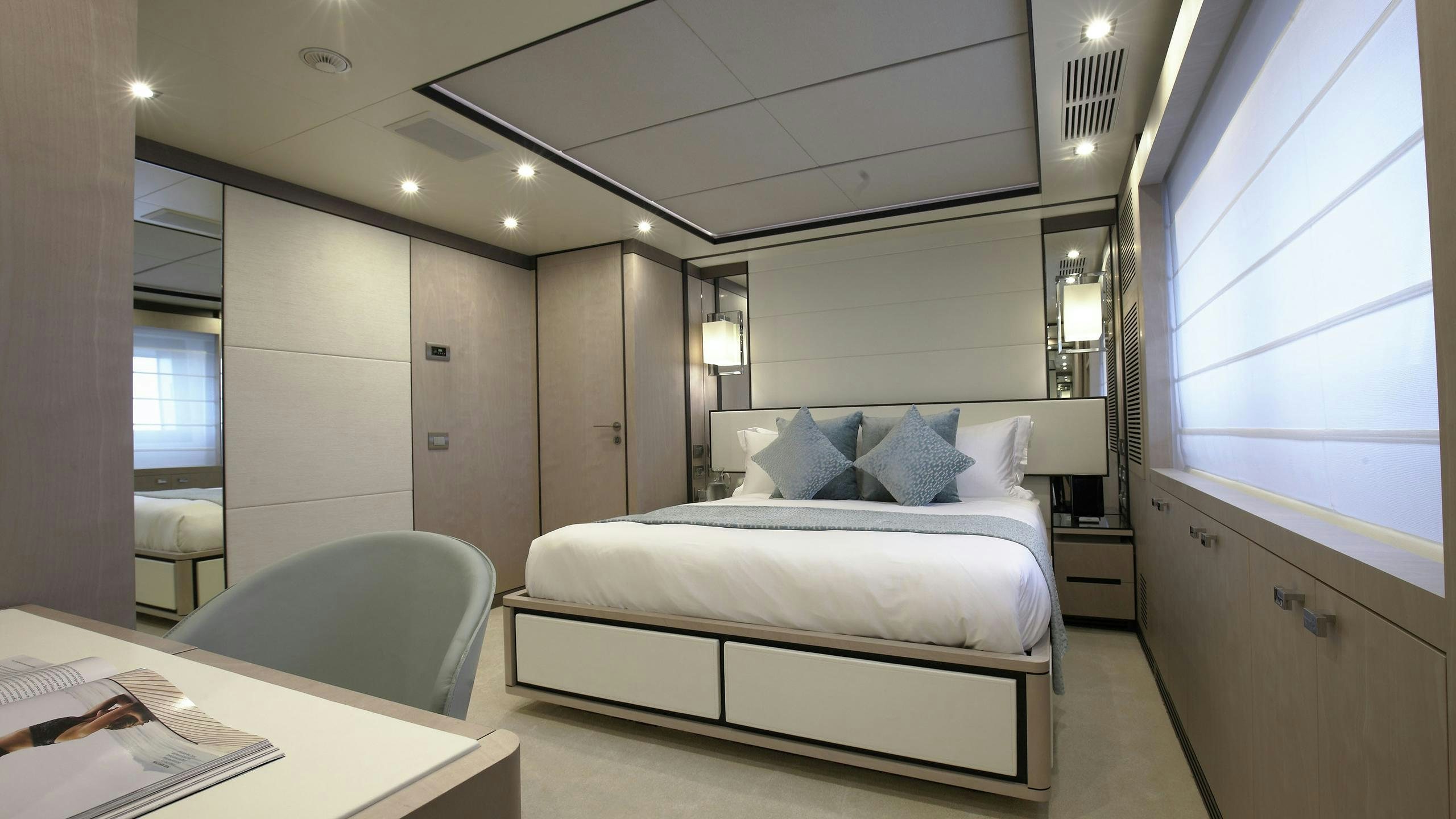 a room with a bed and a desk aboard WILLOW Yacht for Charter