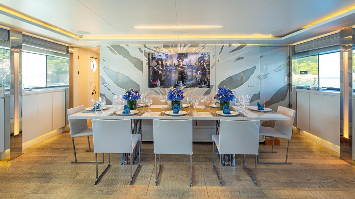 a large dining table with white chairs aboard SEA WOLF Yacht for Charter