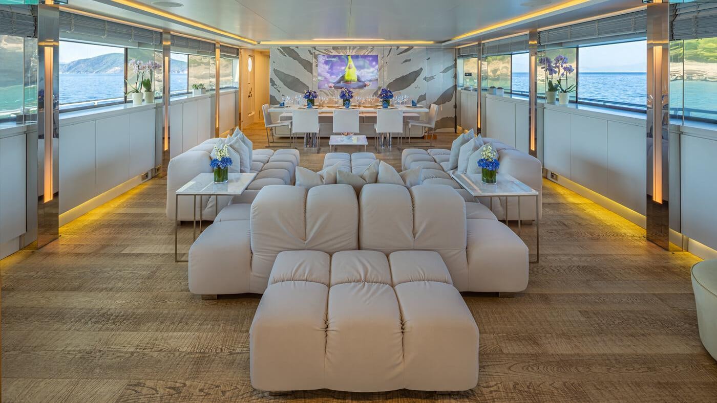 a large room with white chairs and tables aboard SEA WOLF Yacht for Charter