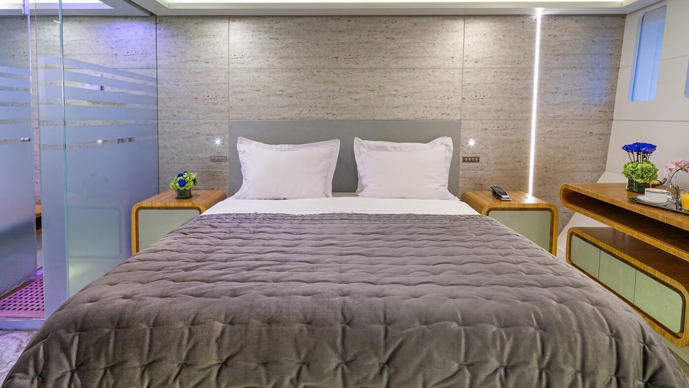 a bed with a white pillow aboard SEA WOLF Yacht for Charter