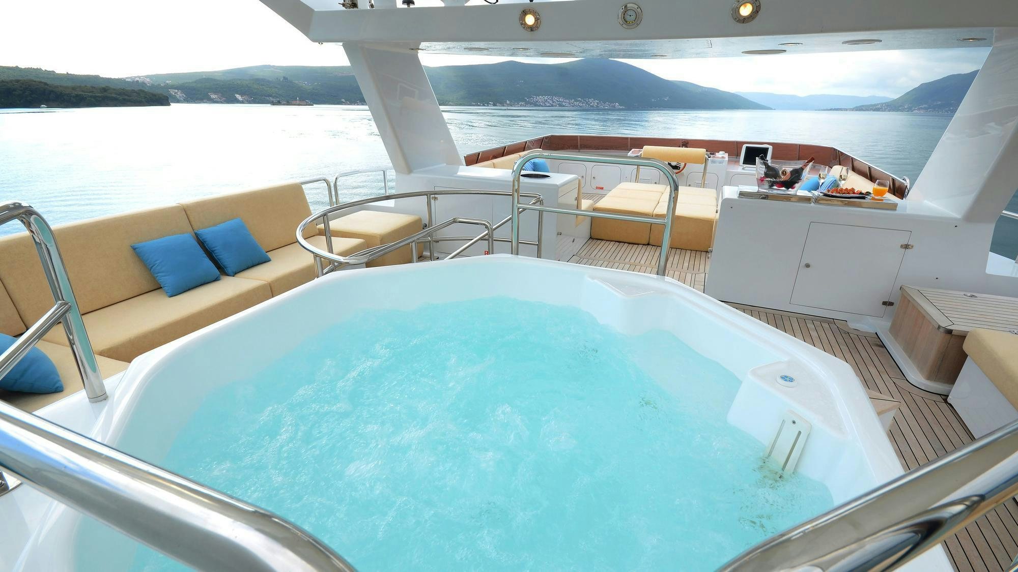 a large white boat with a blue pillow on it aboard LADYSHIP Yacht for Charter