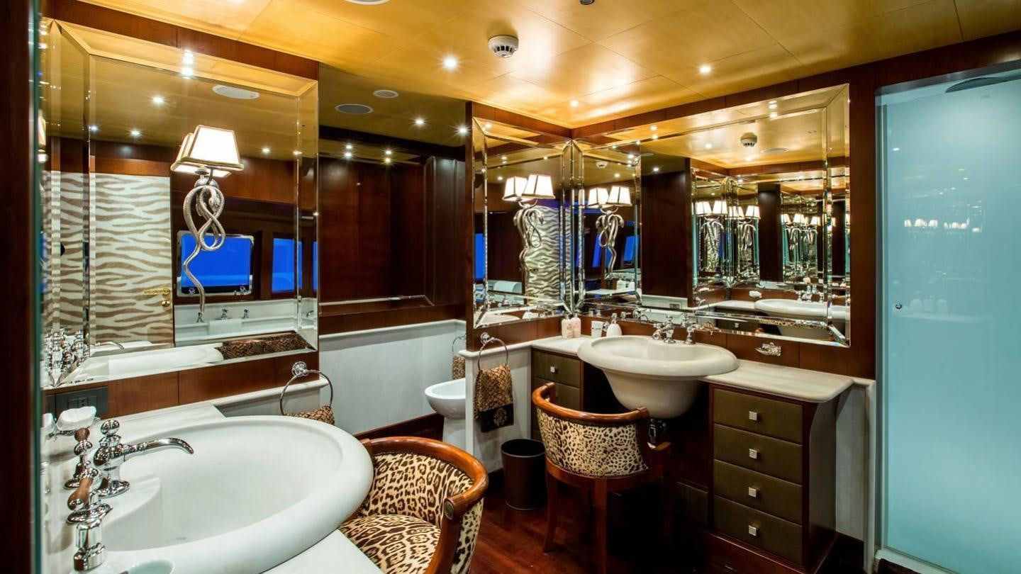 a bathroom with a sink and a mirror aboard AQUILA Yacht for Charter