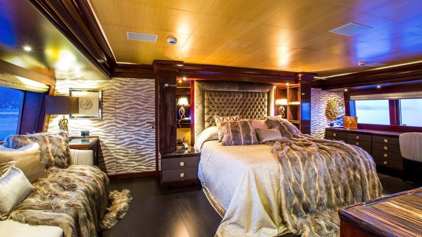 a bedroom with a bed and a couch aboard AQUILA Yacht for Charter