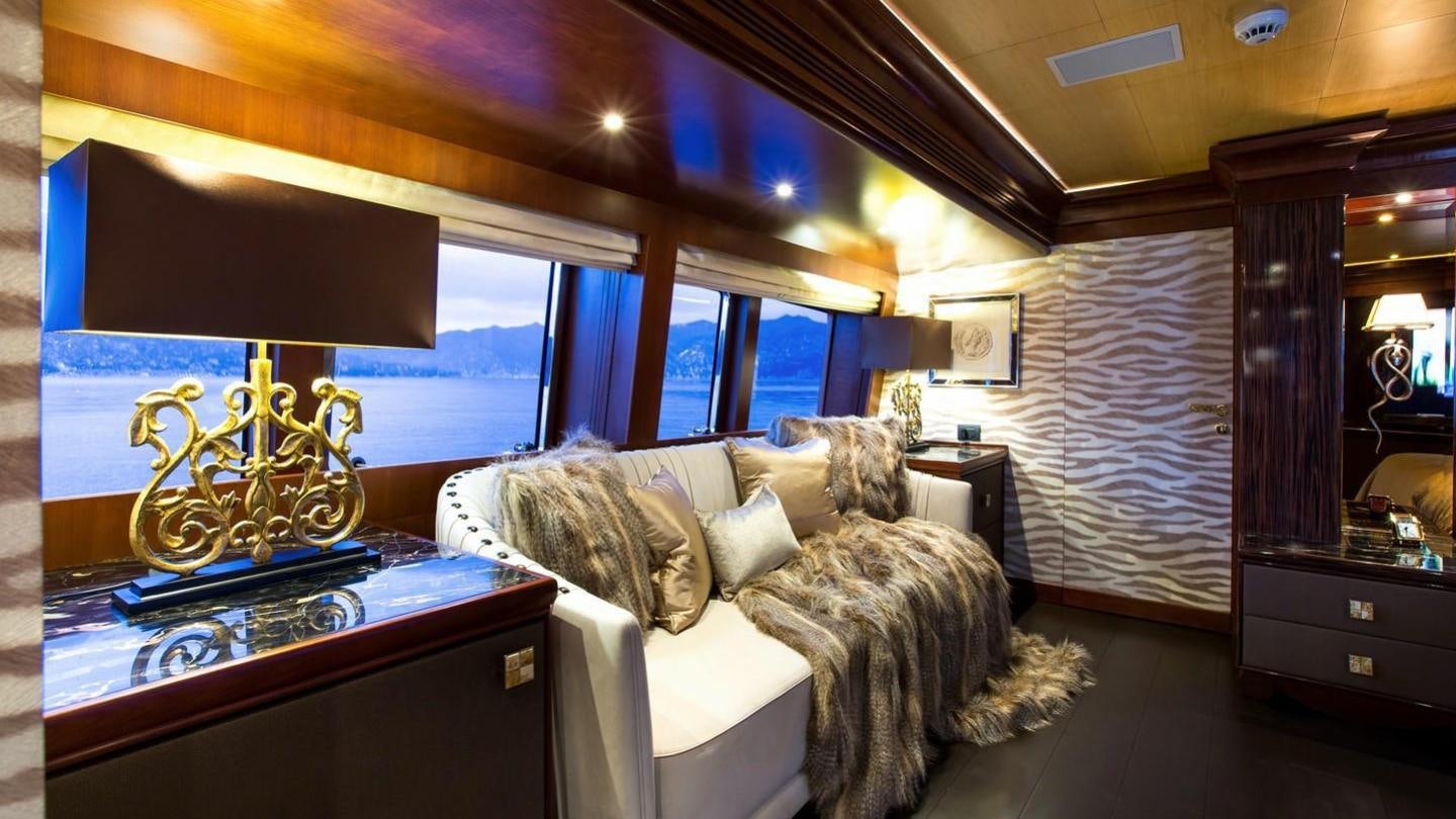 a couple of dogs lying on a couch in a living room aboard AQUILA Yacht for Charter