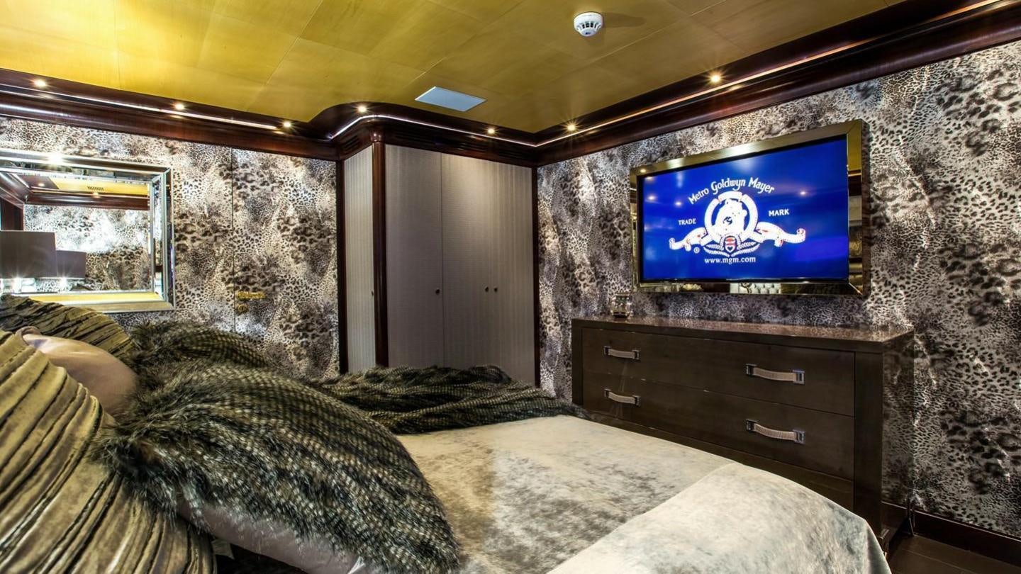 a room with a tv and a bed aboard AQUILA Yacht for Charter