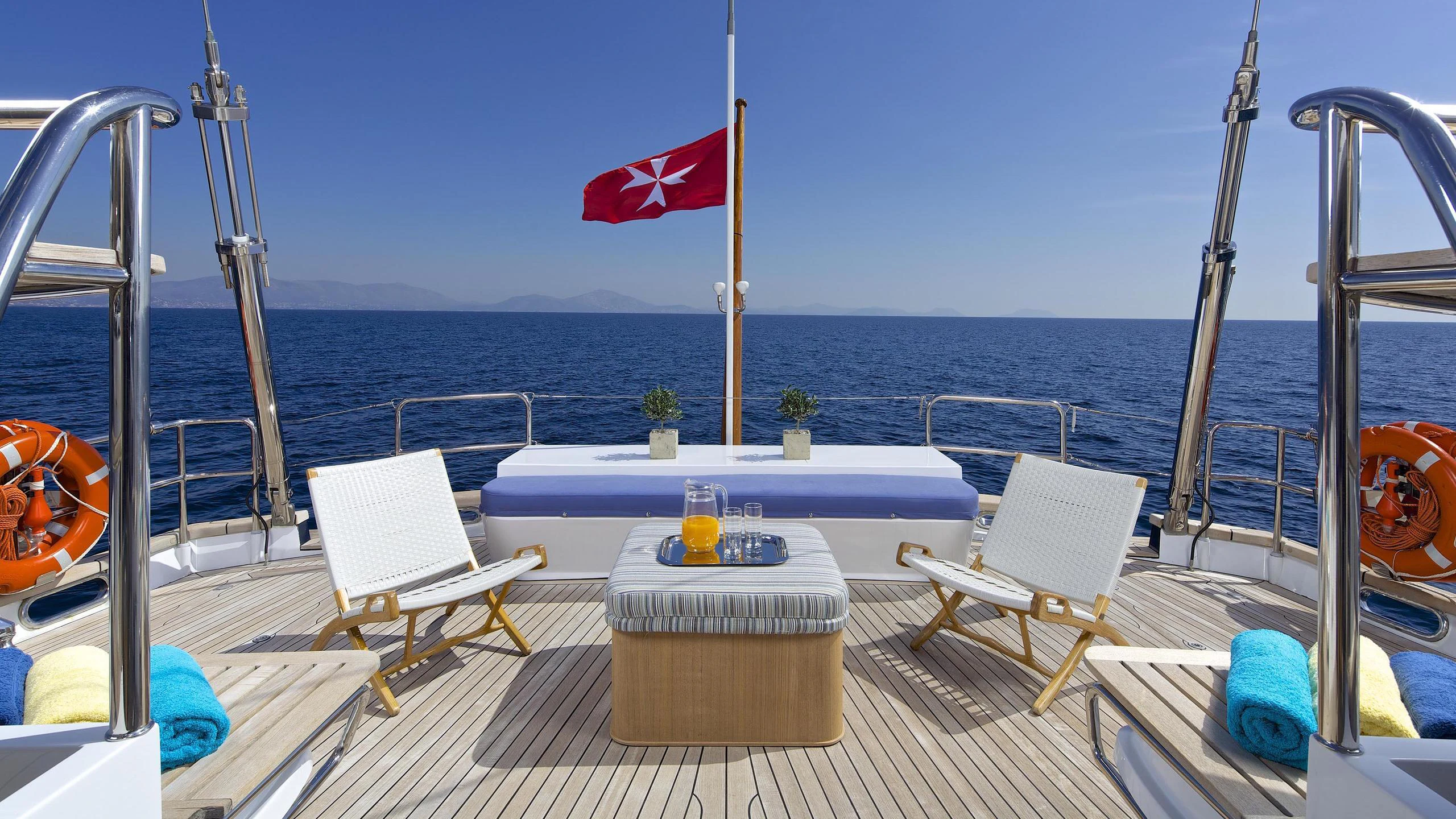 a table and chairs on a boat aboard ALLURE A Yacht for Charter