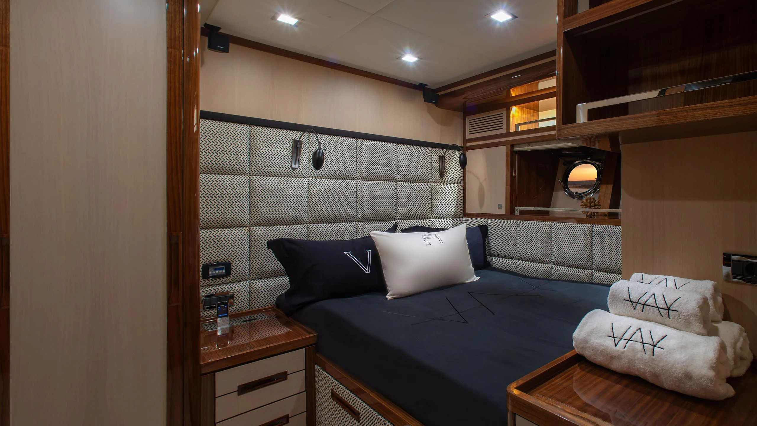a room with a bed and a desk aboard VAY Yacht for Charter
