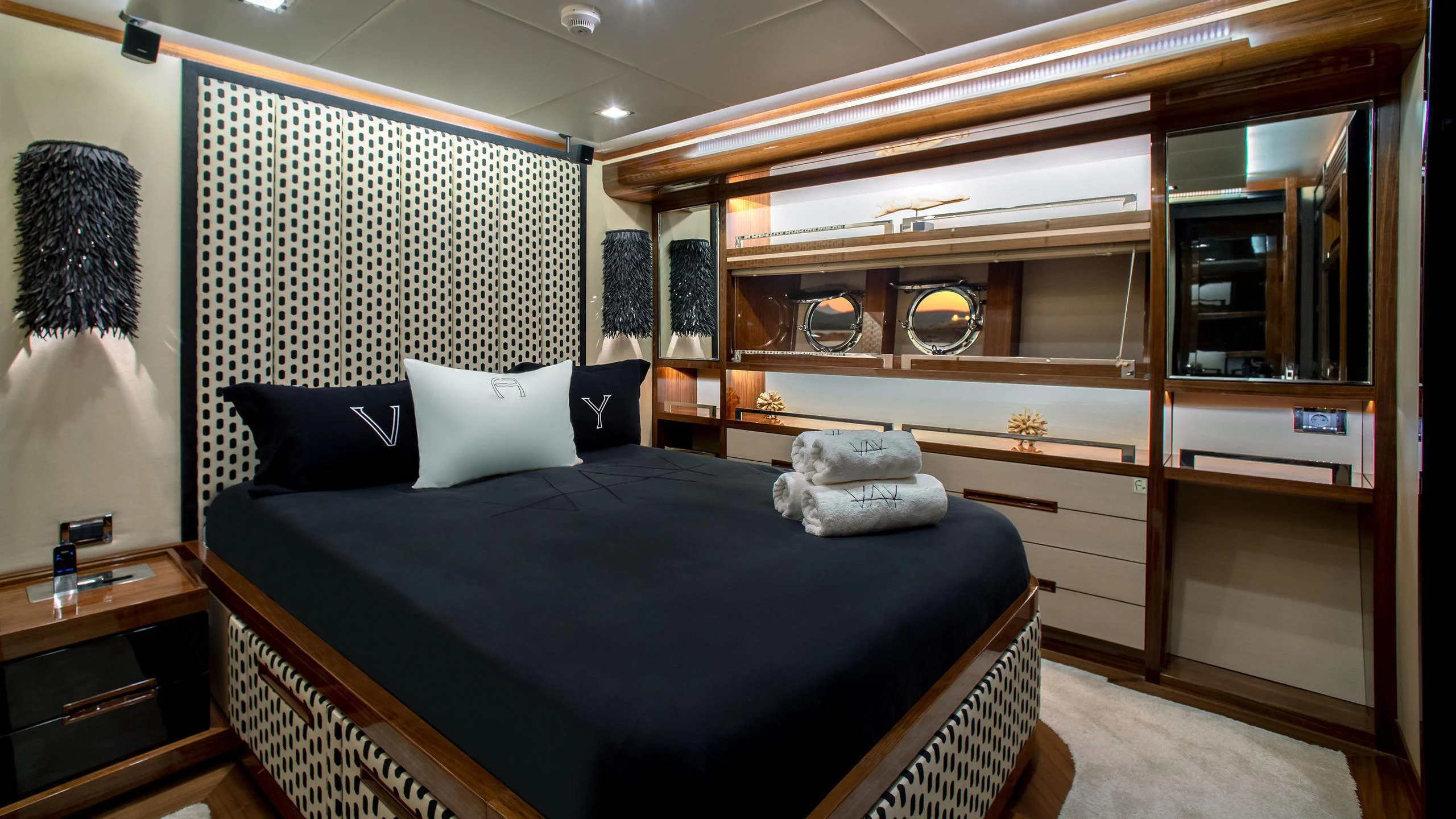 a bedroom with a bed and a mirror aboard VAY Yacht for Charter