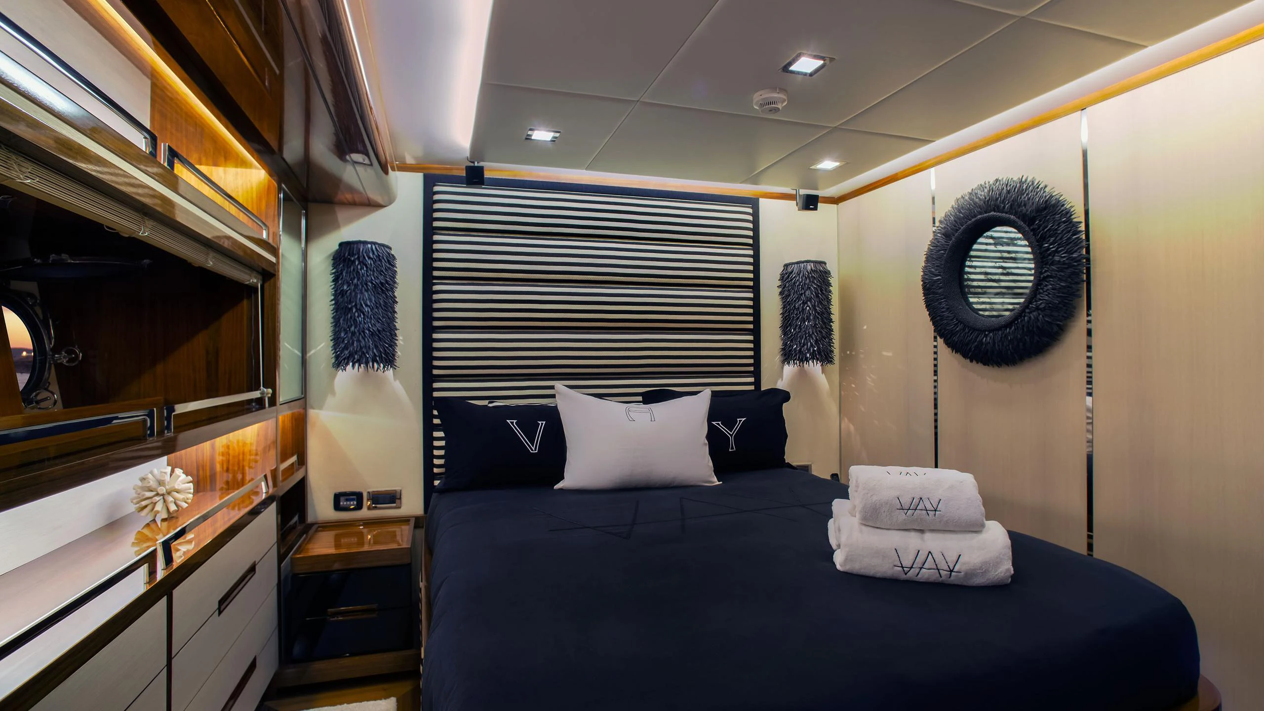 a bedroom with a bed and a fan aboard VAY Yacht for Charter