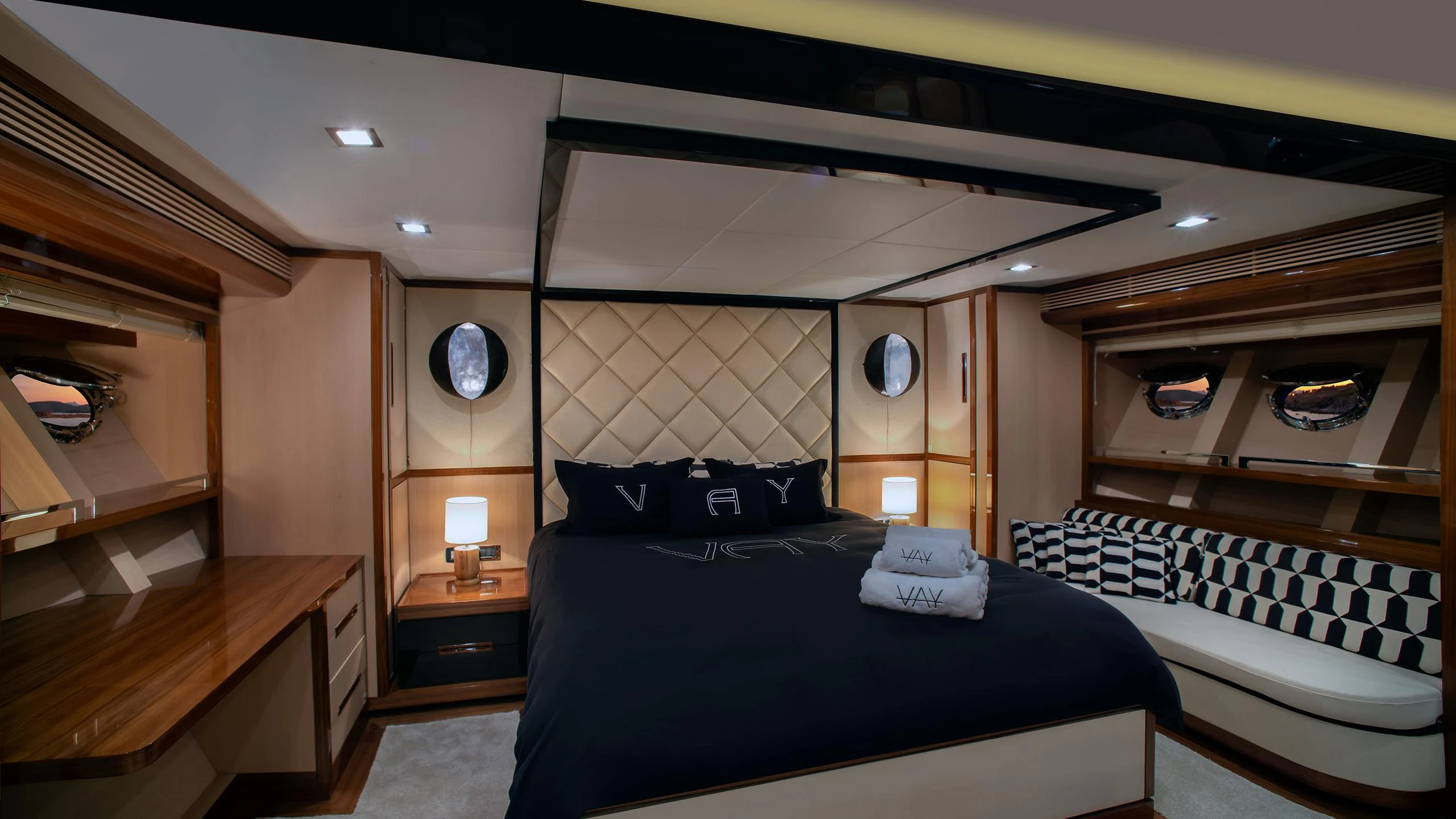 a room with a bed and a desk aboard VAY Yacht for Charter
