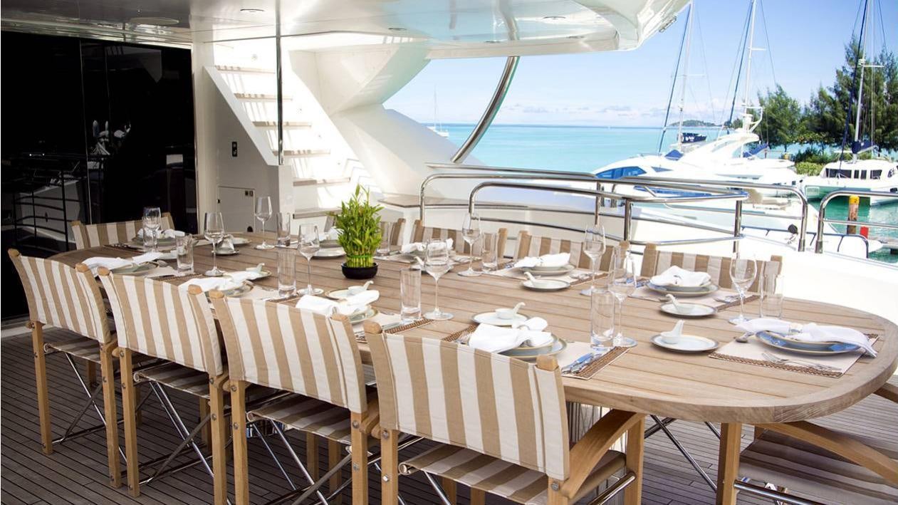 a table set for a dinner aboard LUSIA M Yacht for Charter
