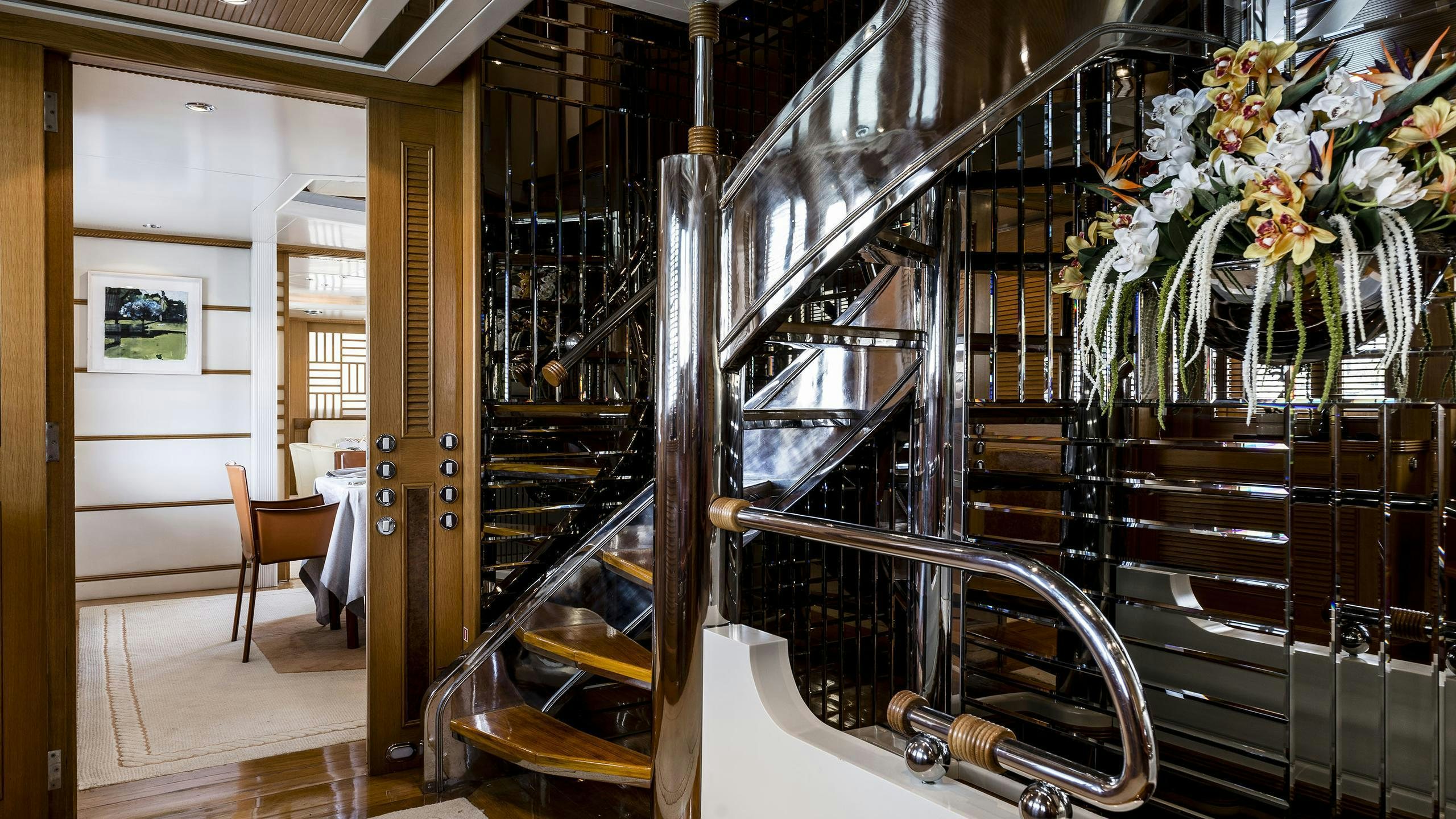 a room with shelves and chairs aboard DESAMIS B Yacht for Charter