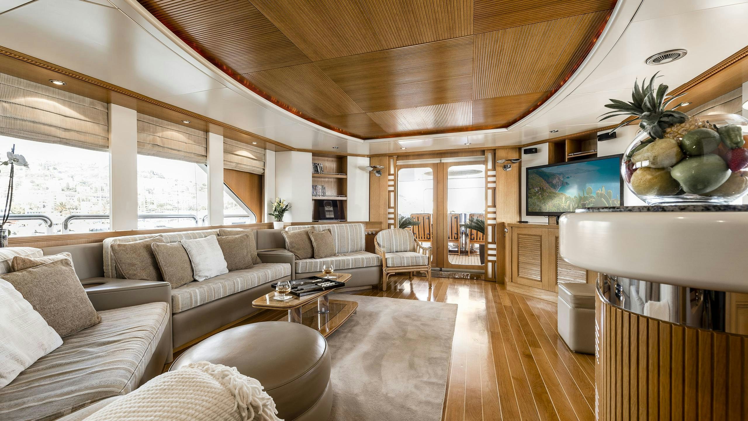 a living room with a large window aboard DESAMIS B Yacht for Charter