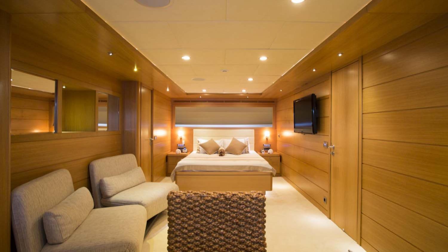 a room with a bed and a tv aboard PANFELISS Yacht for Charter