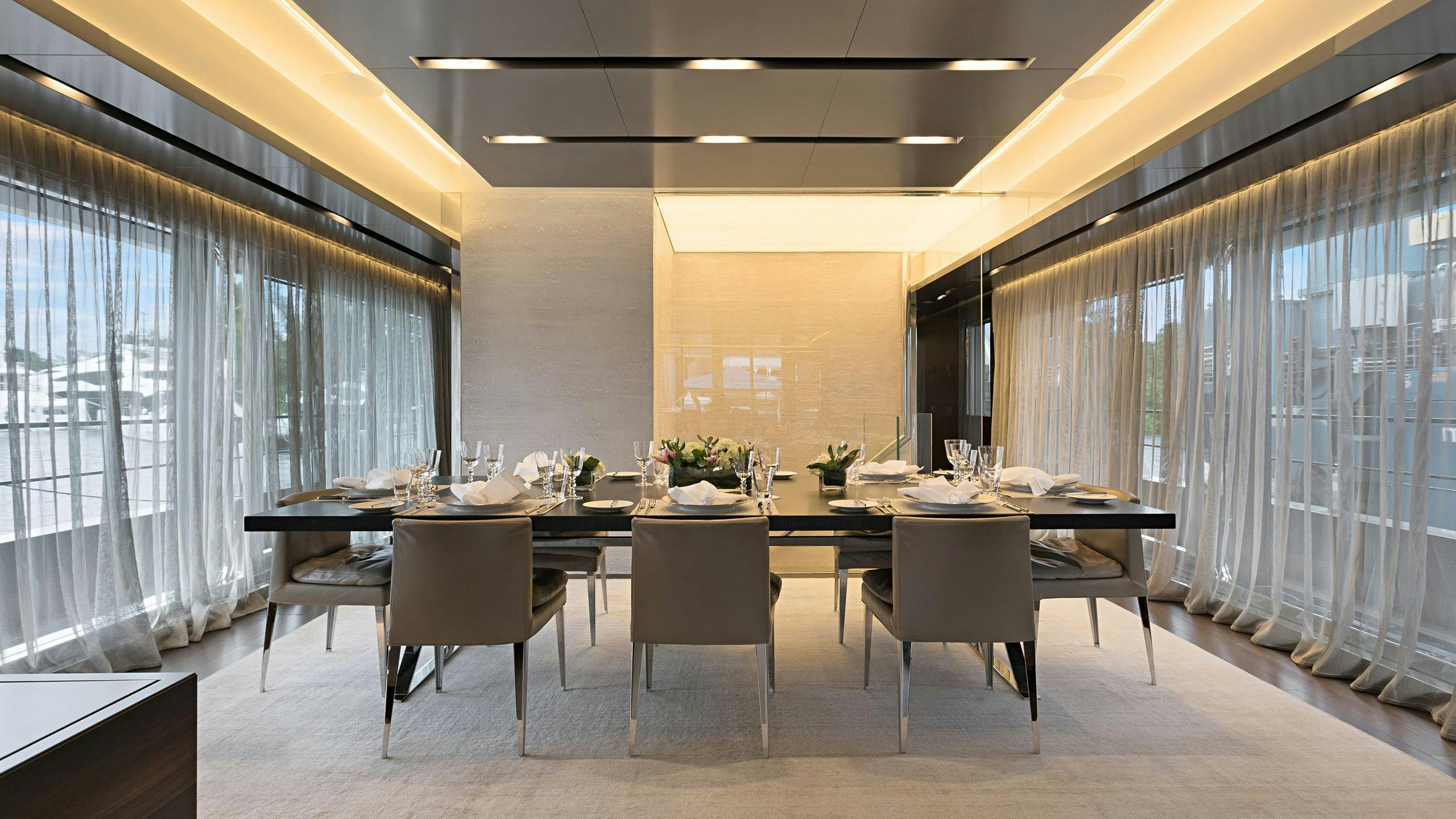 a large conference room with a table and chairs aboard SAFE HAVEN Yacht for Charter