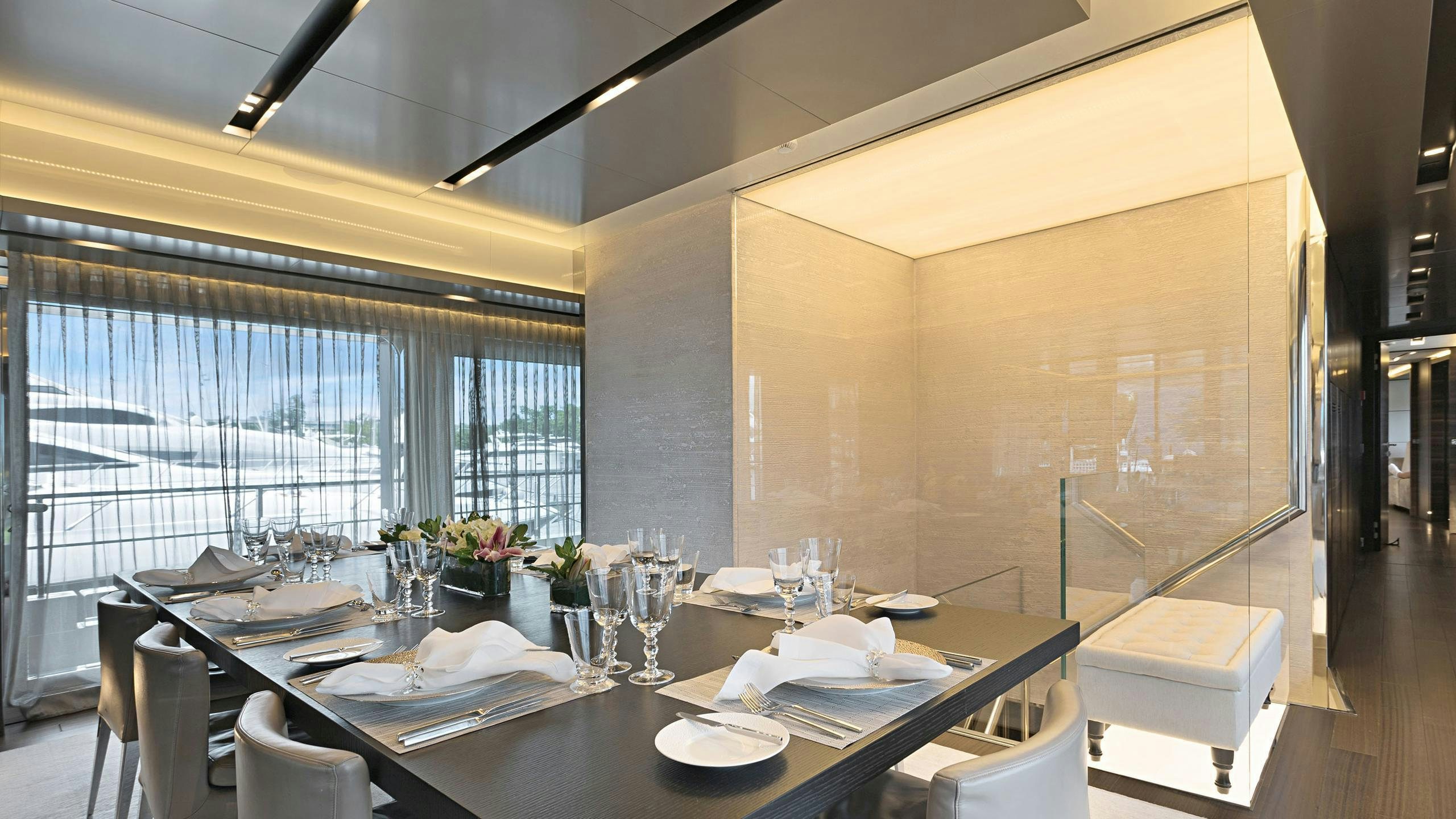 a table with plates and glasses aboard SAFE HAVEN Yacht for Charter