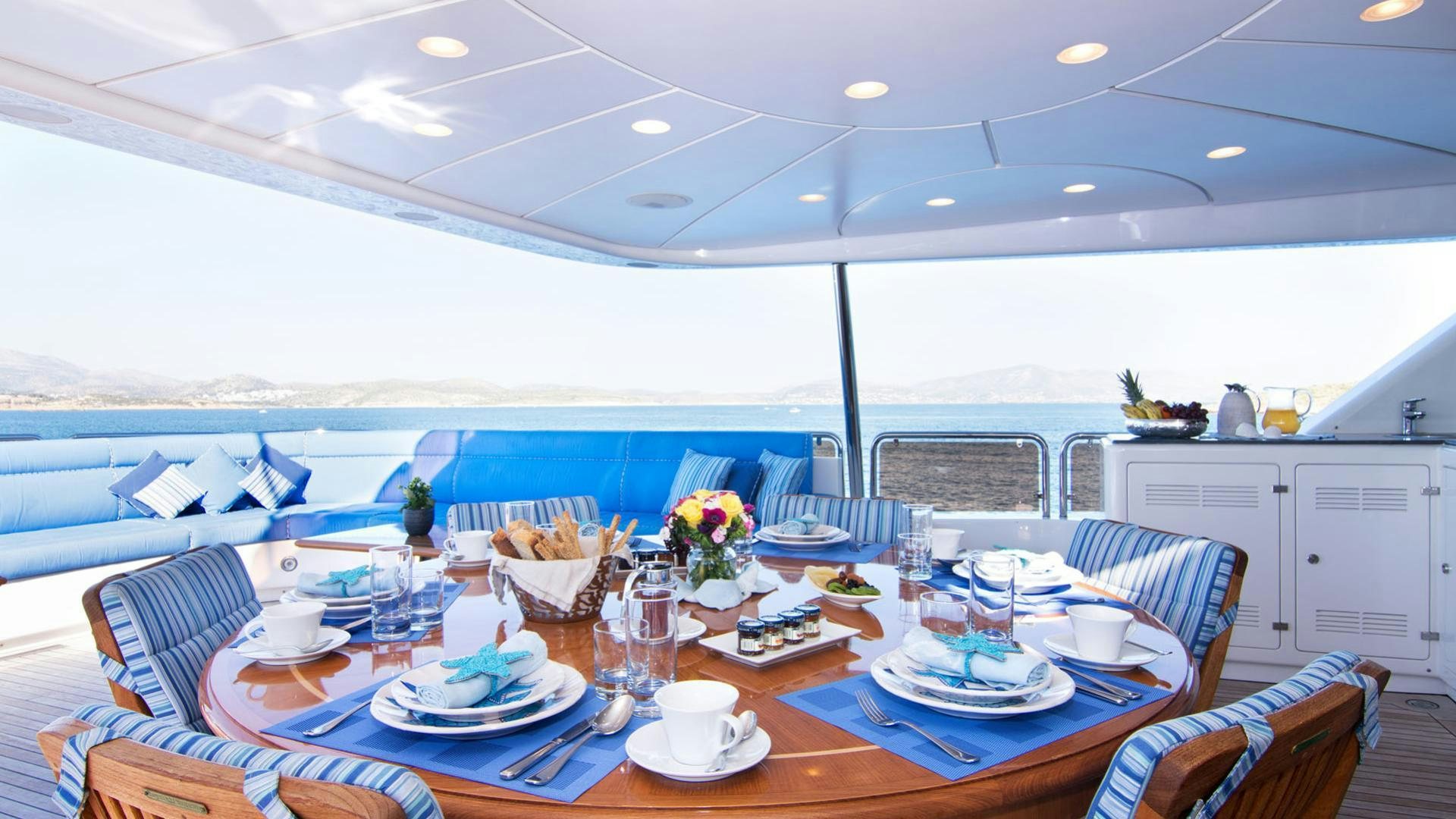 a table with plates and cups on it aboard OPTION B Yacht for Charter
