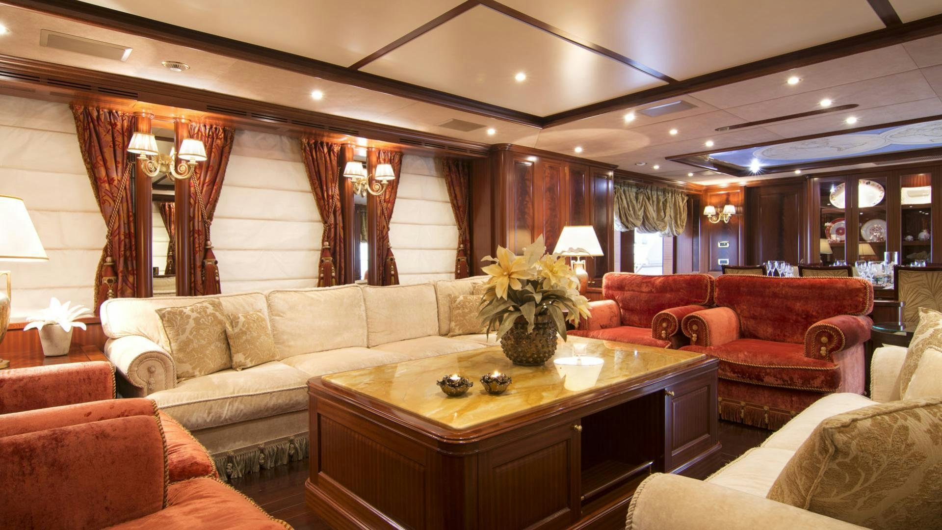 a living room with a large table and couches aboard OPTION B Yacht for Charter
