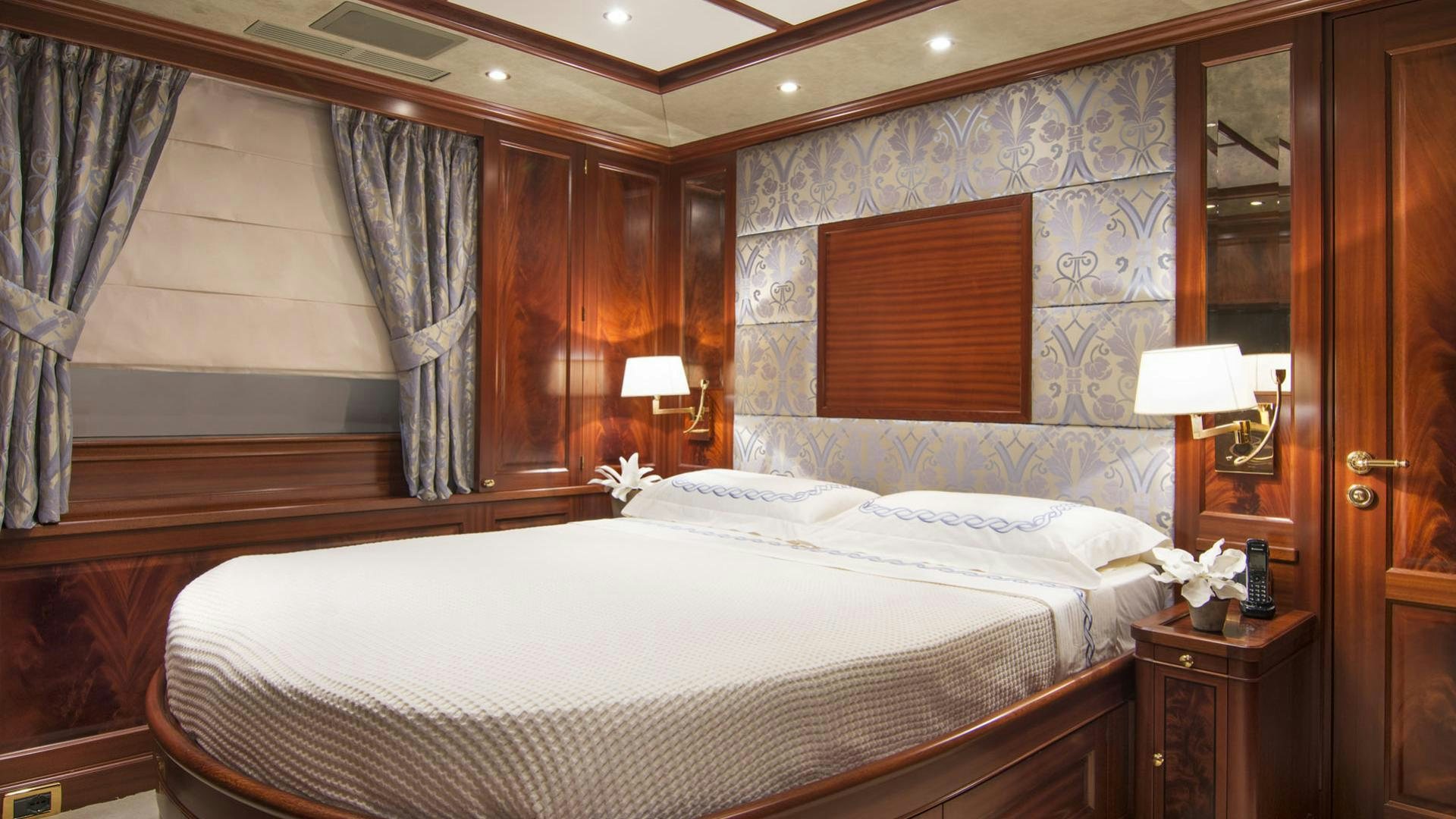 a bedroom with a large bed aboard OPTION B Yacht for Charter