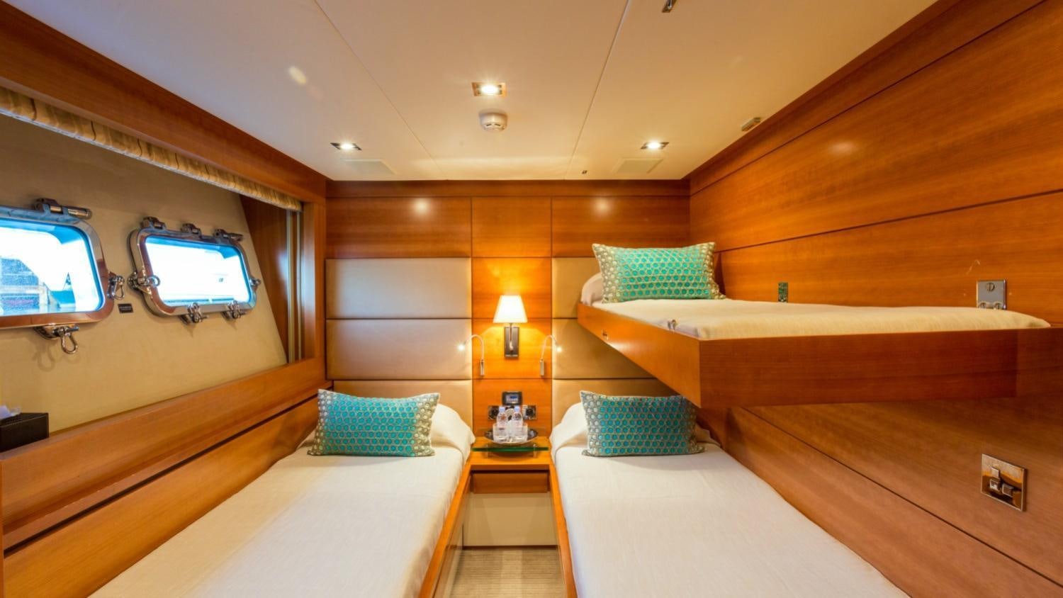 a room with a bed and a desk aboard ARION Yacht for Charter