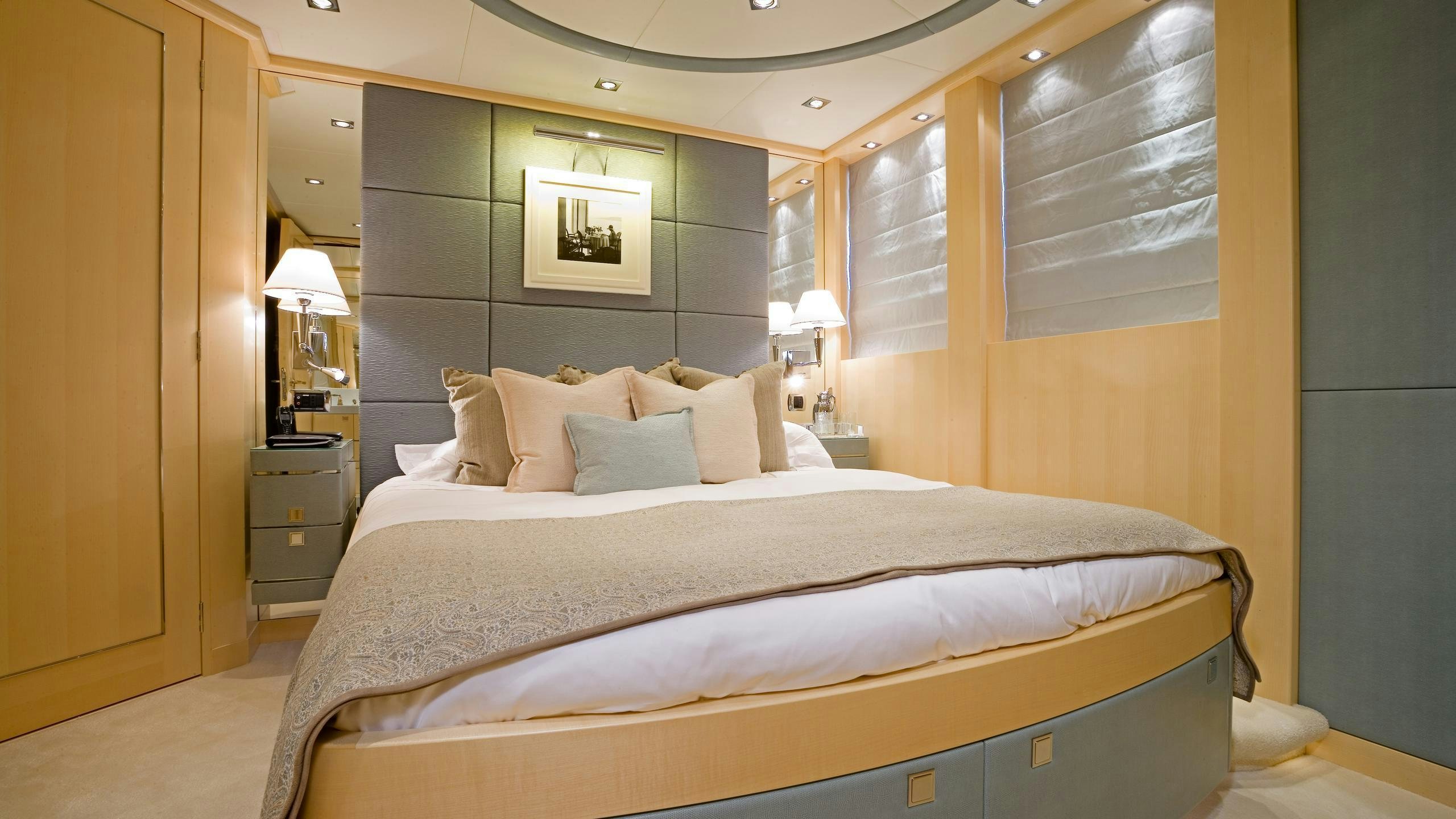 a bed with a white comforter aboard G-FORCE Yacht for Charter