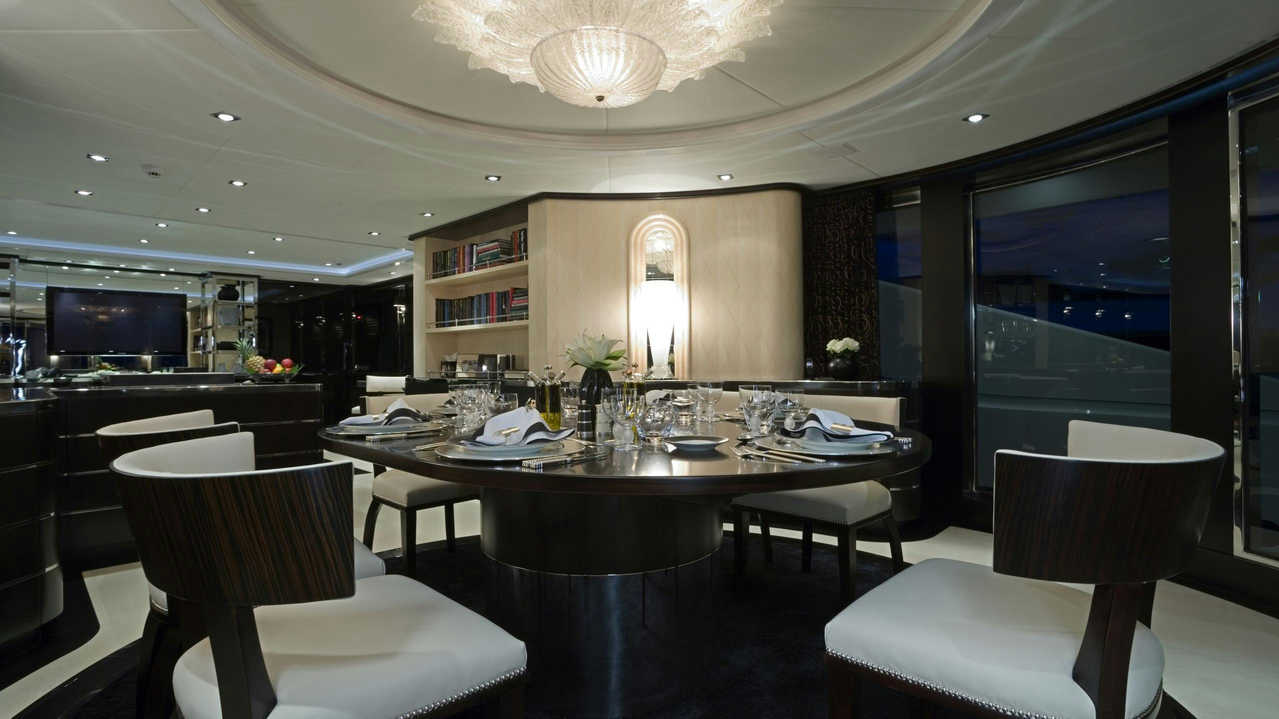 a large dining table in a room aboard G-FORCE Yacht for Charter