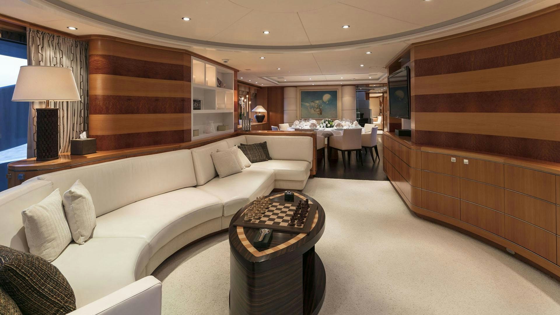 a living room with a couch and a coffee table aboard L'EQUINOX Yacht for Charter