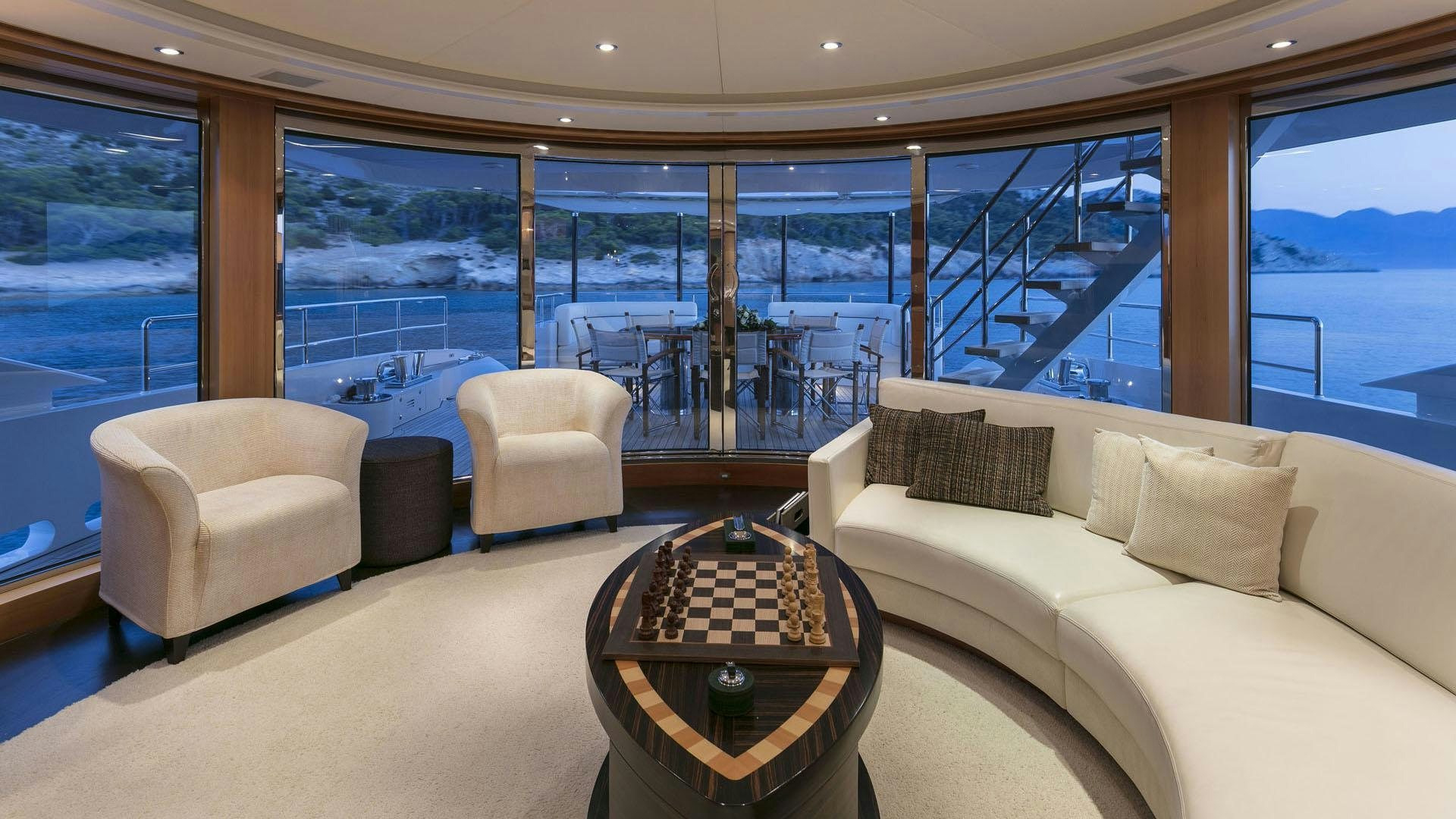 a living room with a large window aboard L'EQUINOX Yacht for Charter