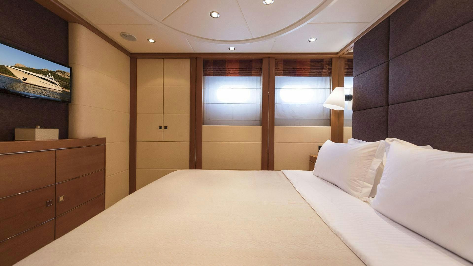a bed with white sheets aboard L'EQUINOX Yacht for Charter