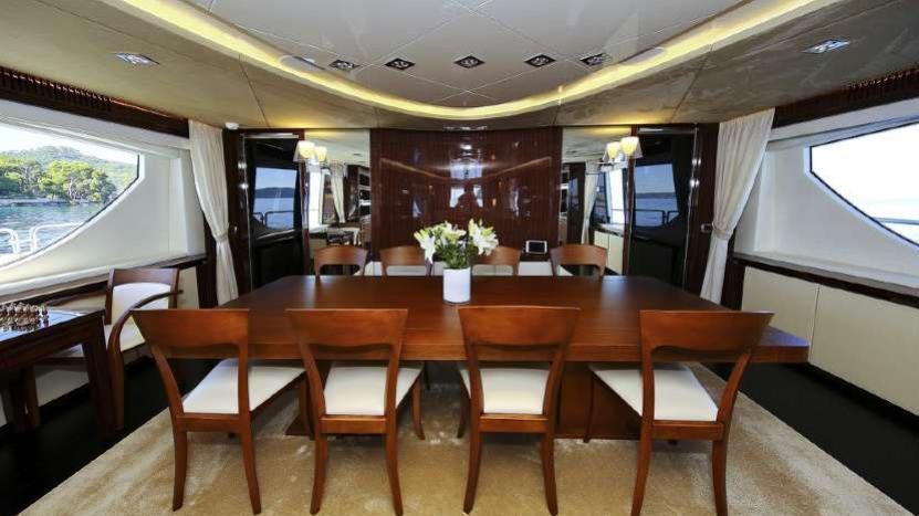 a table with chairs and a bench aboard ARTEMY Yacht for Charter