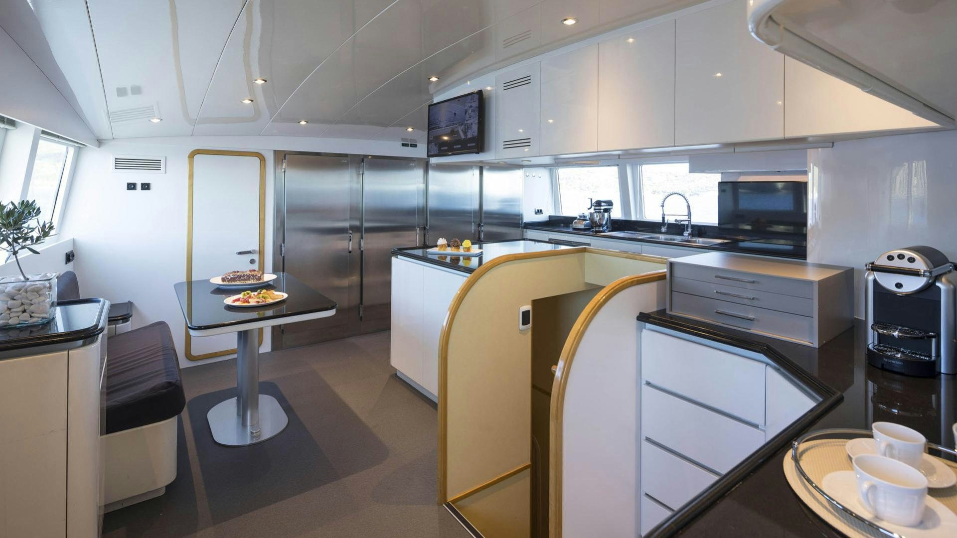 a kitchen with white cabinets aboard SOLE DI MARE Yacht for Charter