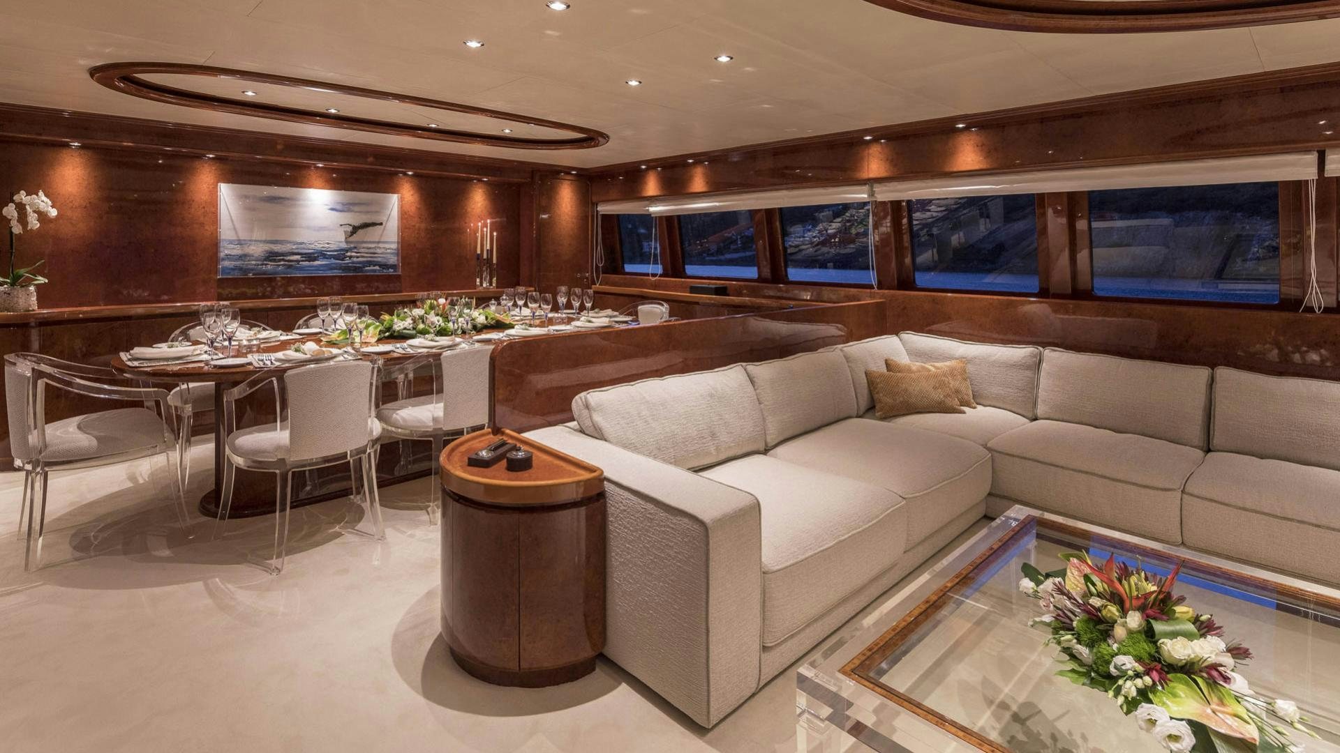 a living room with a couch and a table aboard SOLE DI MARE Yacht for Charter