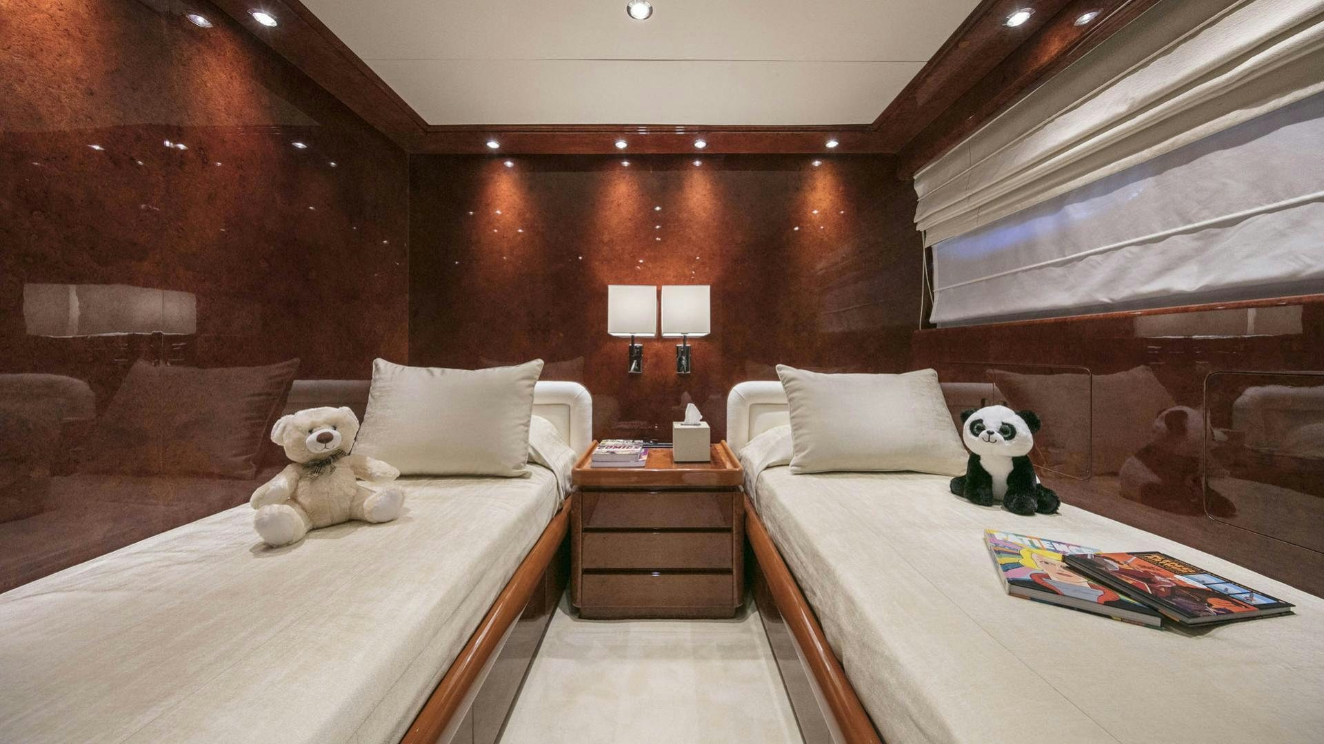 a room with a bed and a teddy bear aboard SOLE DI MARE Yacht for Charter