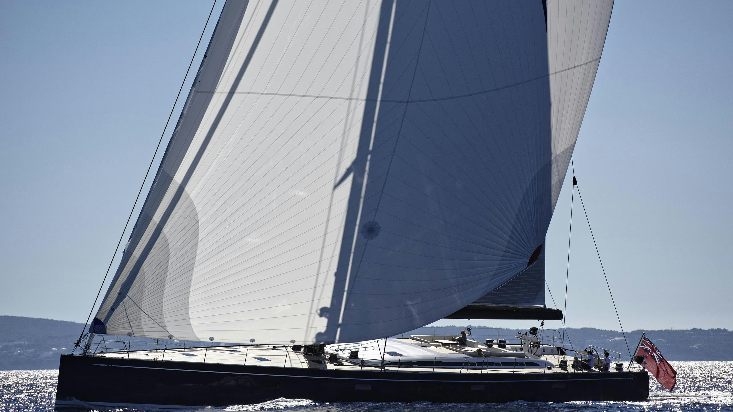 a boat with a flag on the front aboard DARLIN Yacht for Charter