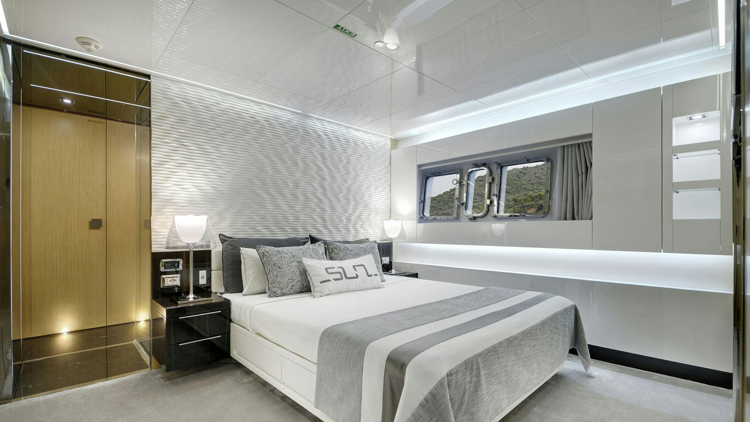 a room with a bed and a desk aboard SUN Yacht for Charter