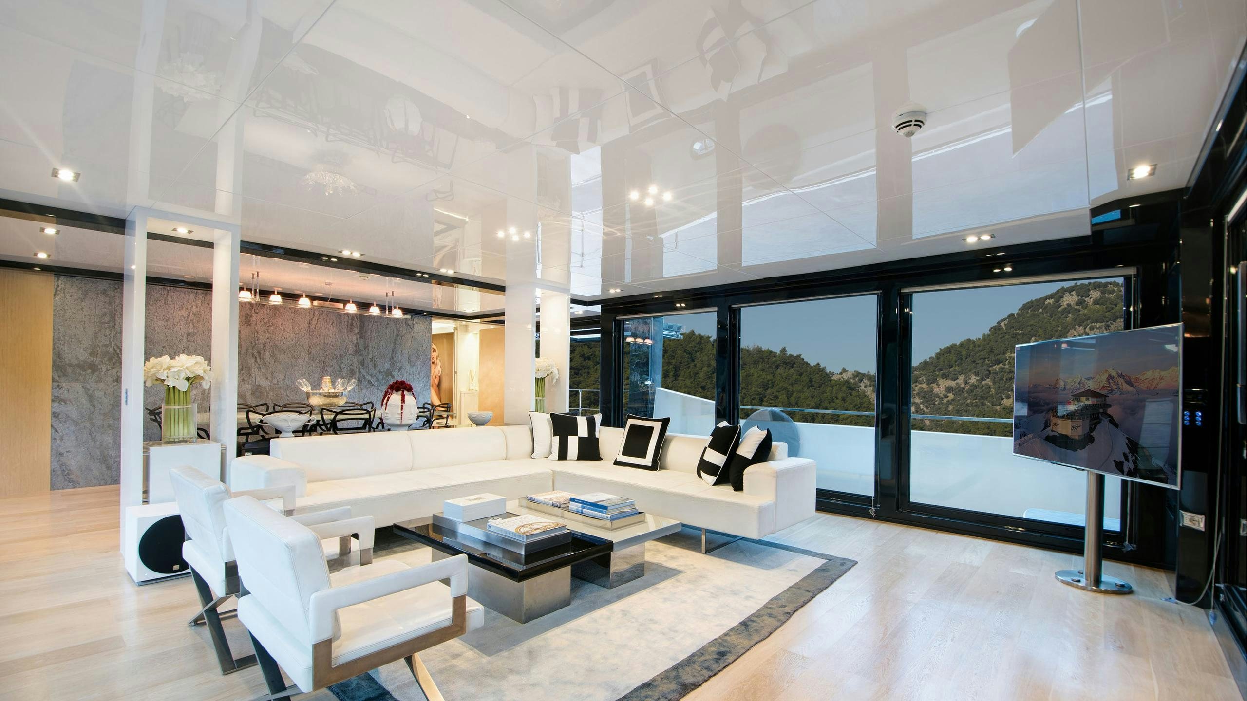 a modern living room with a large glass wall aboard SUN Yacht for Charter