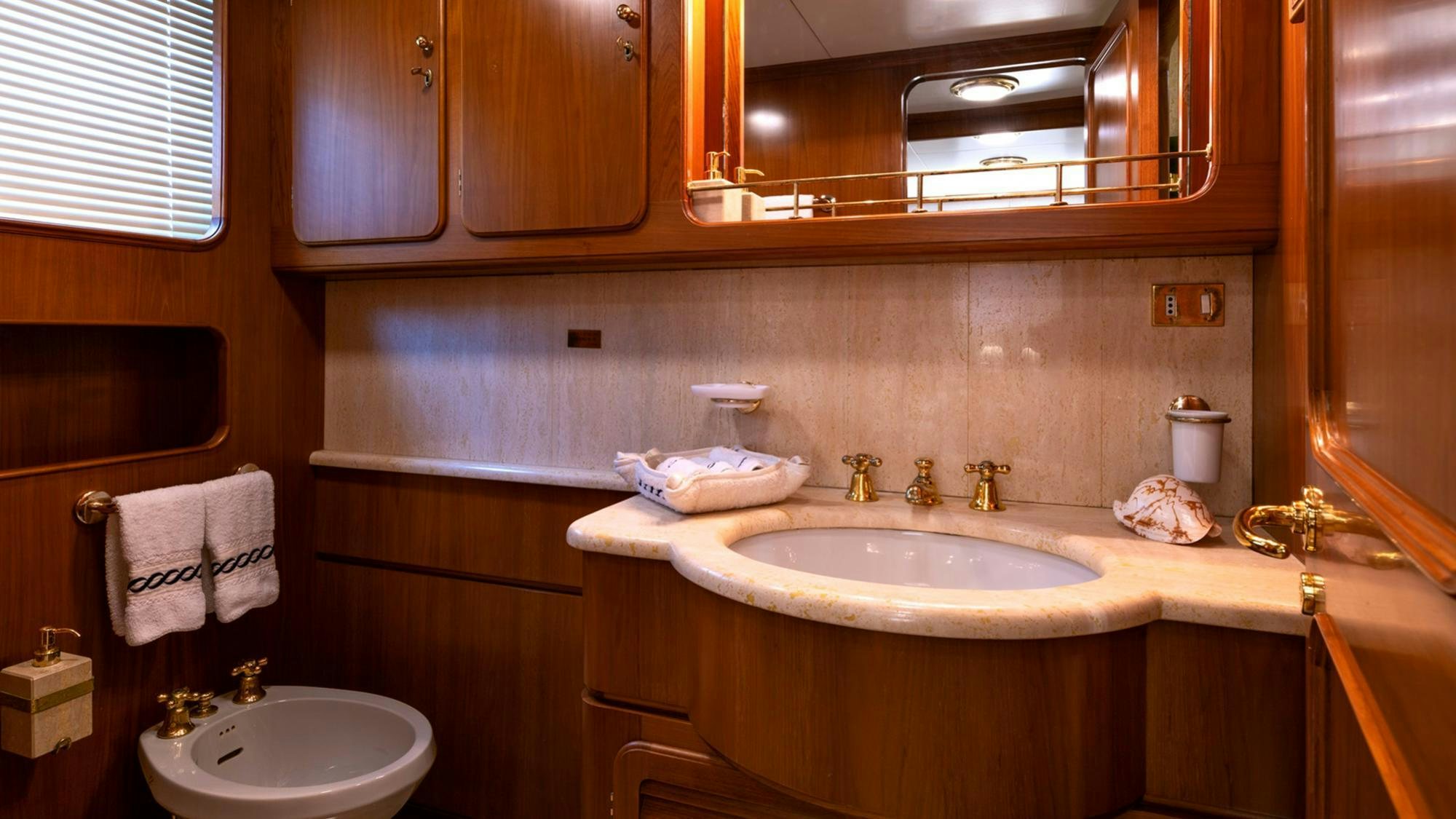 a bathroom with a sink and a mirror aboard NIGHTFLOWER Yacht for Charter