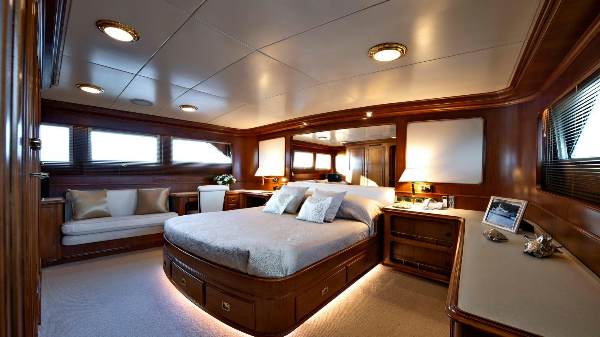 a room with a bed and a desk aboard NIGHTFLOWER Yacht for Charter